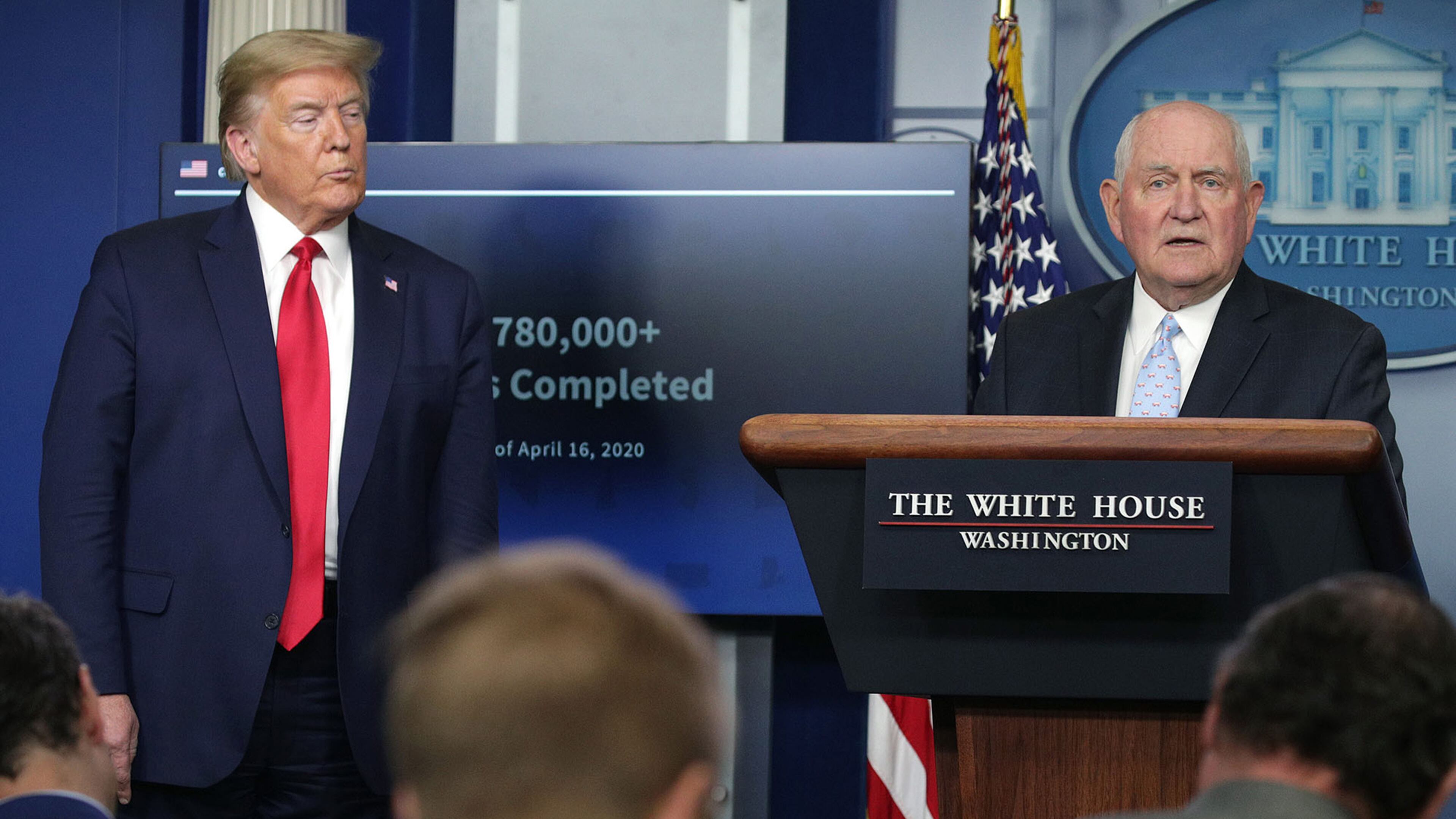 Secretary of Agriculture Sonny Perdue, right, speaks as President Donald Trump looks on during the daily briefing of the White House Coronavirus Task Force, at the White House in Washington, D.C., on Friday, April 17, 2020. (Alex Wong/Getty Images/TNS)