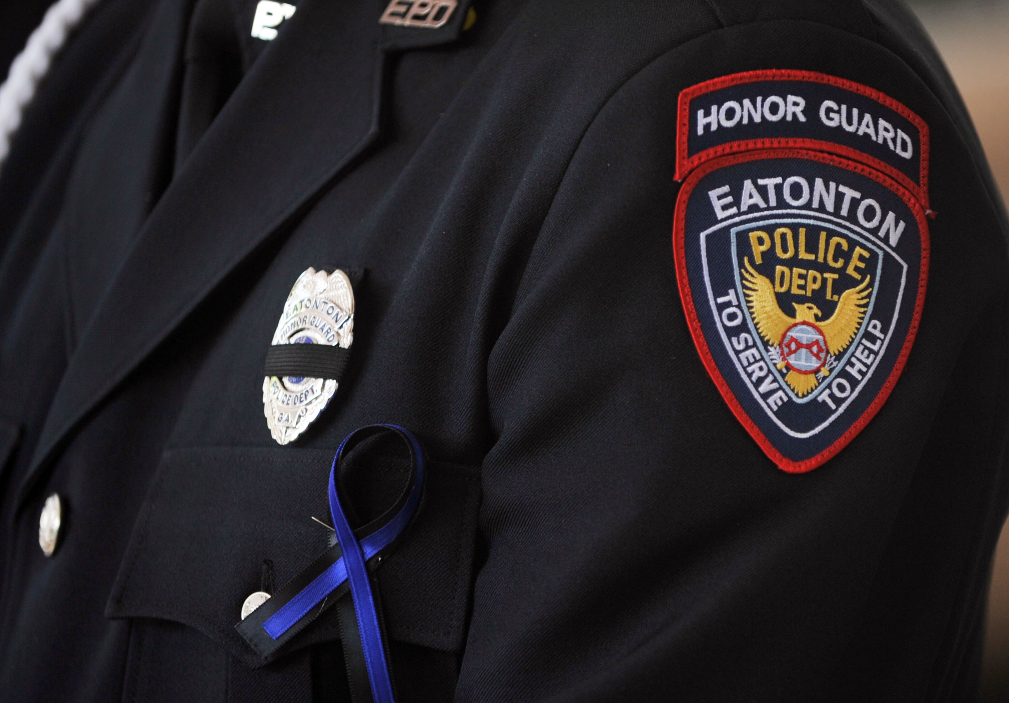 Family members, friends and officers from several law enforcement agencies attend funeral services for Eatonton police officer Noel Lee Hawk, 52 of Madison, at the A. E. Carter Funeral Home in Madson, Ga., on Wednesday, May, 7, 2014. Here, an Eatonton Police officer stands as part of the honor guard before the service. Officer Hawk "loved people and never met a stranger," reserve officer Shane Hill said. "He truly loved to be a police officer."