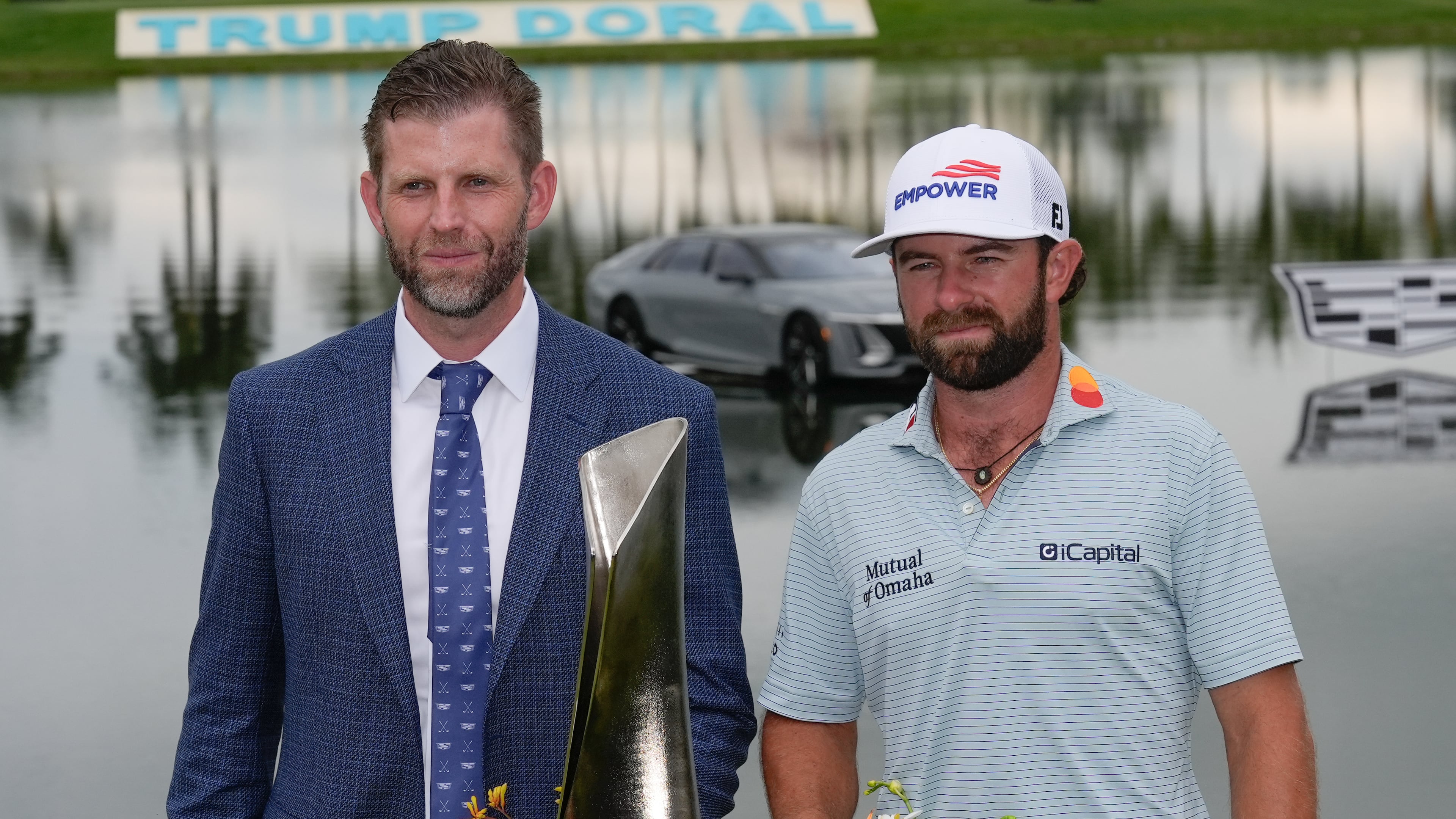 Cameron Young, right, stands with Eric Trump as he poses with the trophy after winning the Cadillac Championship PGA golf tournament Sunday, May 3, 2026, in Doral, Fla. (AP Photo/David J. Phillip)