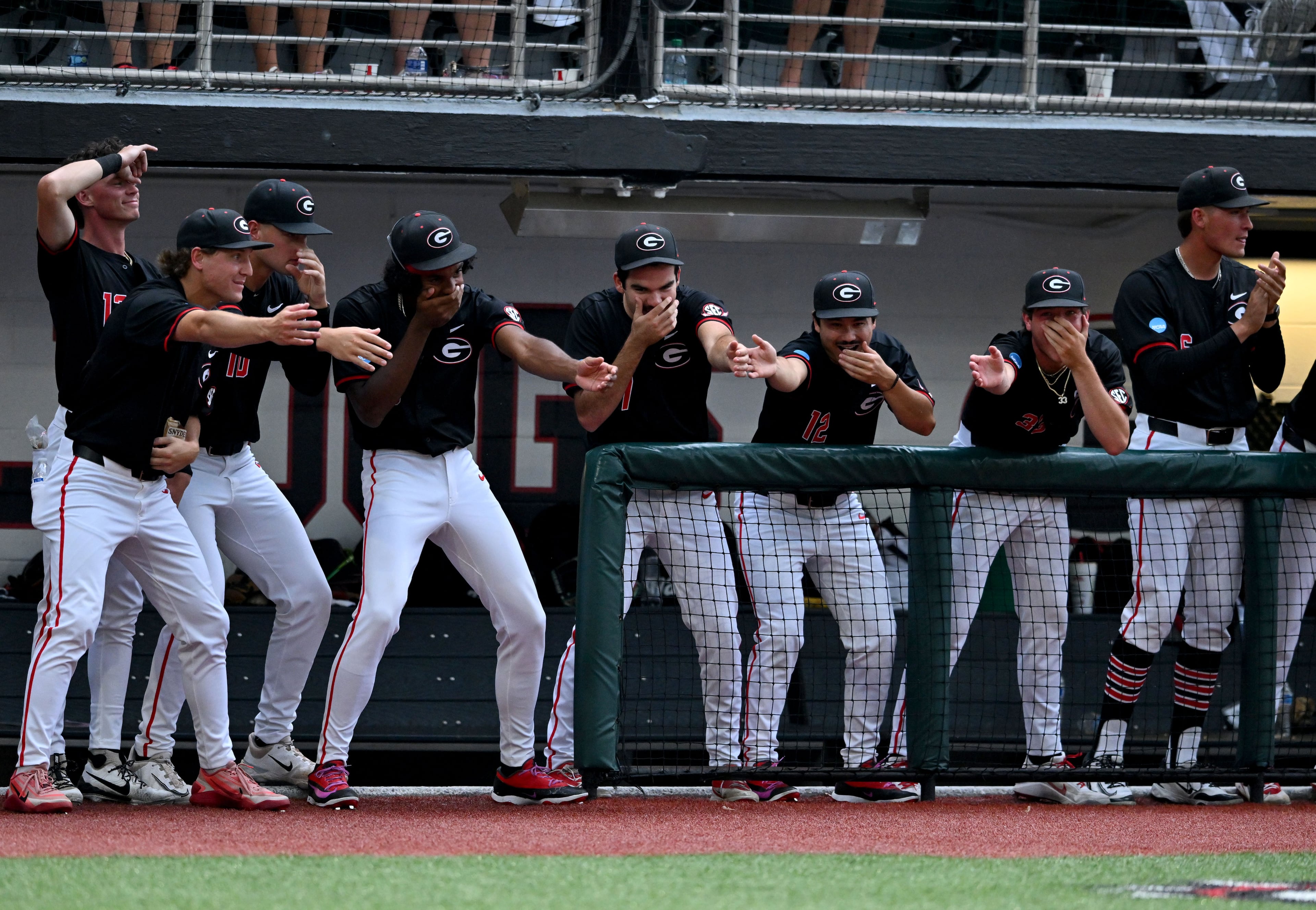 Georgia players react as catcher Daniel Jackson (3) hits a solo home run during the fifth inning of their NCAA Regional game at Foley Field, Friday, May 29, 2026, in Athens. (Hyosub Shin/AJC)