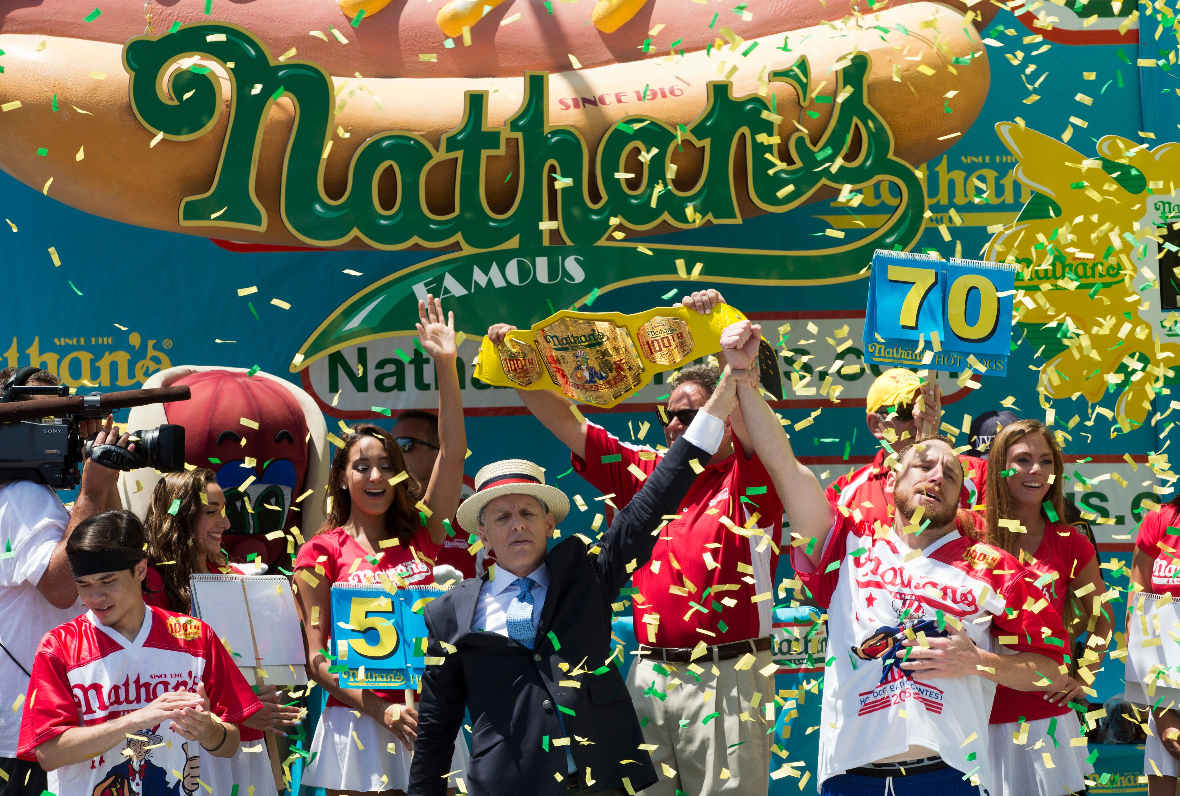 Joey Chestnut, right, is declared Nathan's Famous Fourth of July International Hot Dog Eating Contest men's competition winner, Monday, July 4, 2016, in New York. Chestnut came in first eating 70 hot dogs and buns in 10 minutes. Matt Stonie came in second eating 53 hot dogs and buns in 10 minutes. (AP Photo/Mary Altaffer)