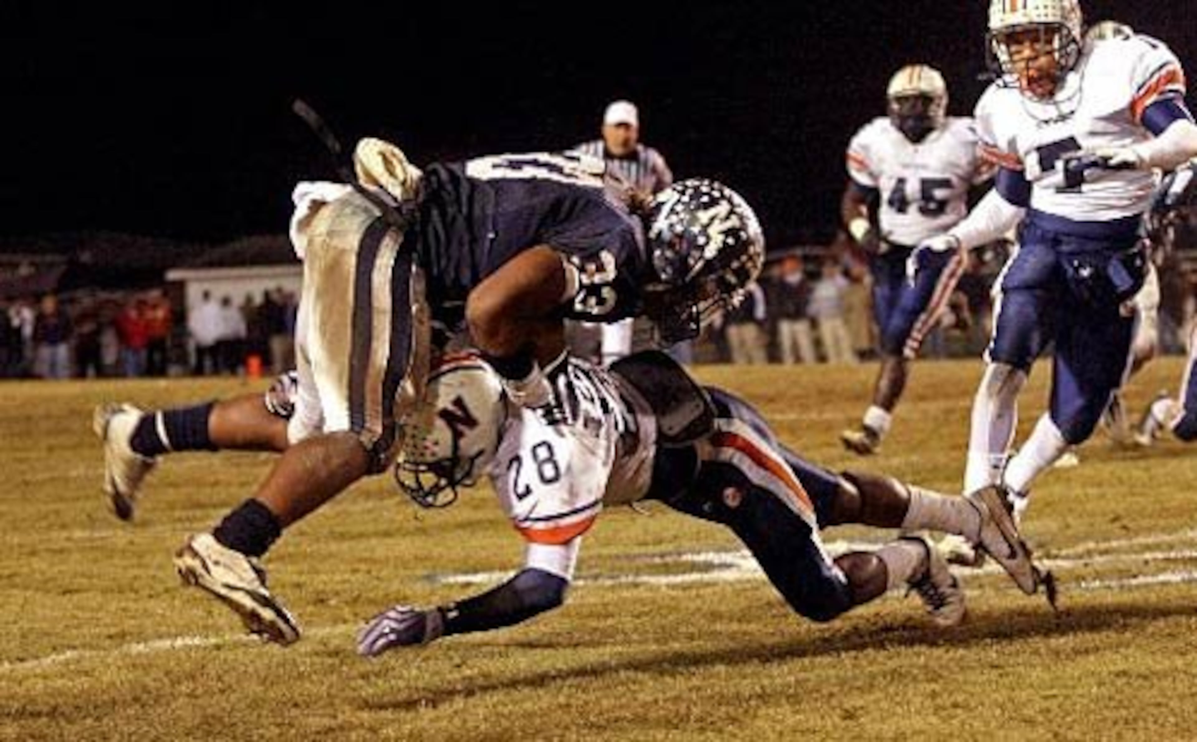 Newnan receiver Alexander Ogletree (33) is stopped by Northside-Warner Robins defender Dontavious Anderson (28) after a first down by Ogletree during the first half.