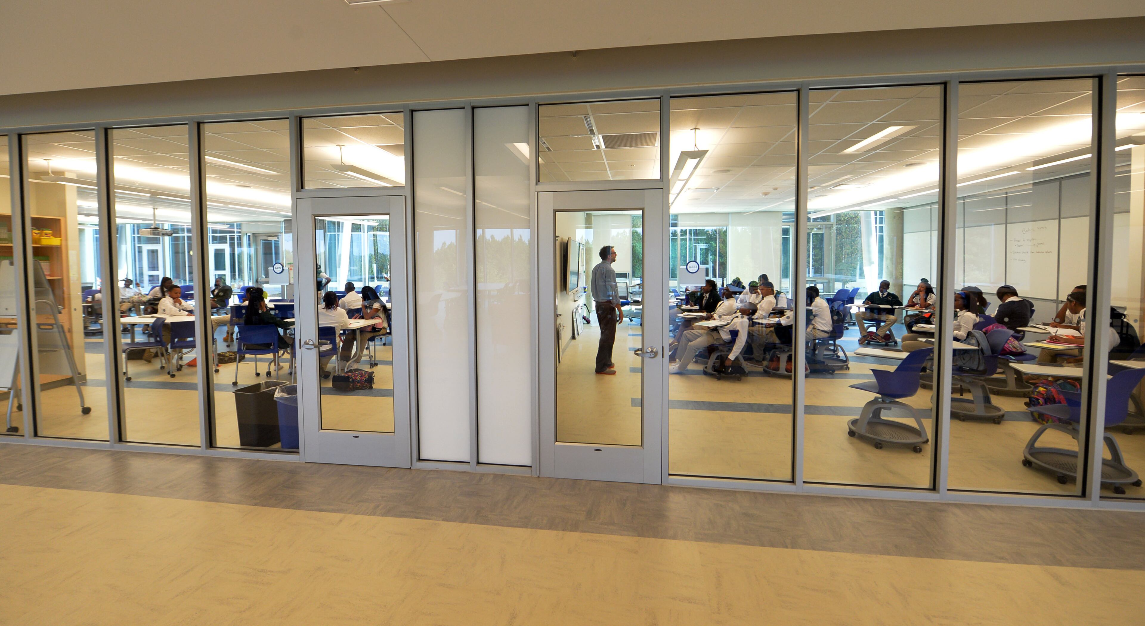 Classrooms have glass on both sides.