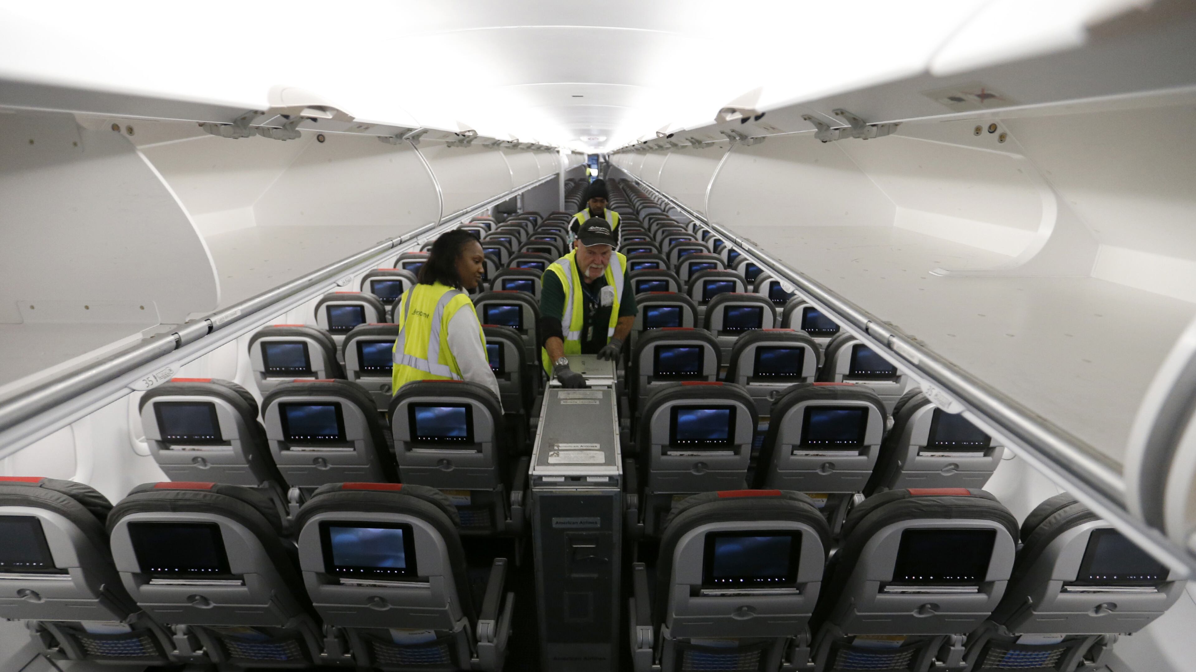 A food service worker unloads food carts aboard an American Airlines flight to Orlando, Fla at Los Angeles International Airport. (Allen J. Schaben/Los Angeles Times/TNS)