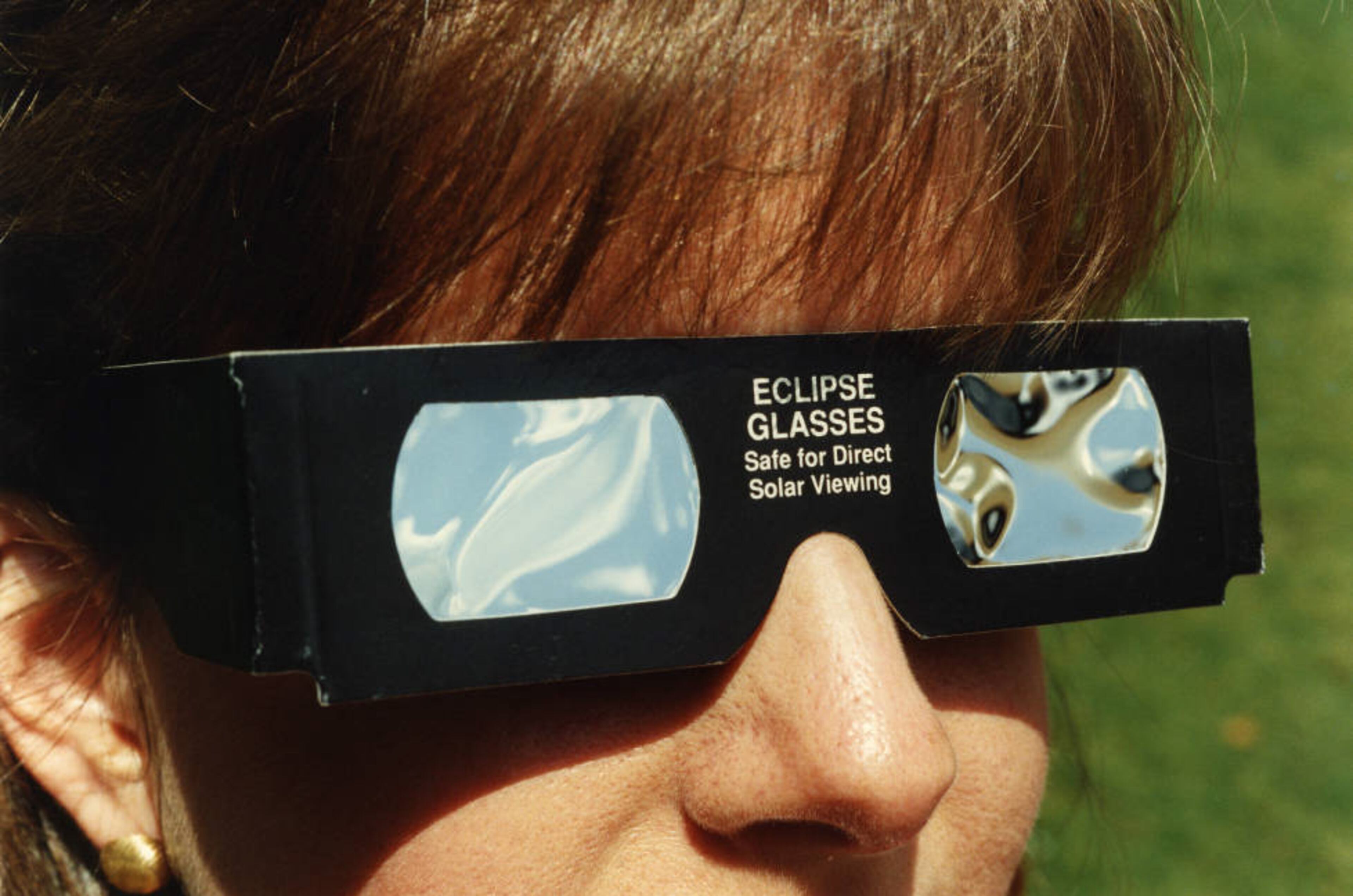From 1991: "Special glasses for watching eclipse are being modeled by Nancy Jackson of Snellville, Georgia who is a bank teller."