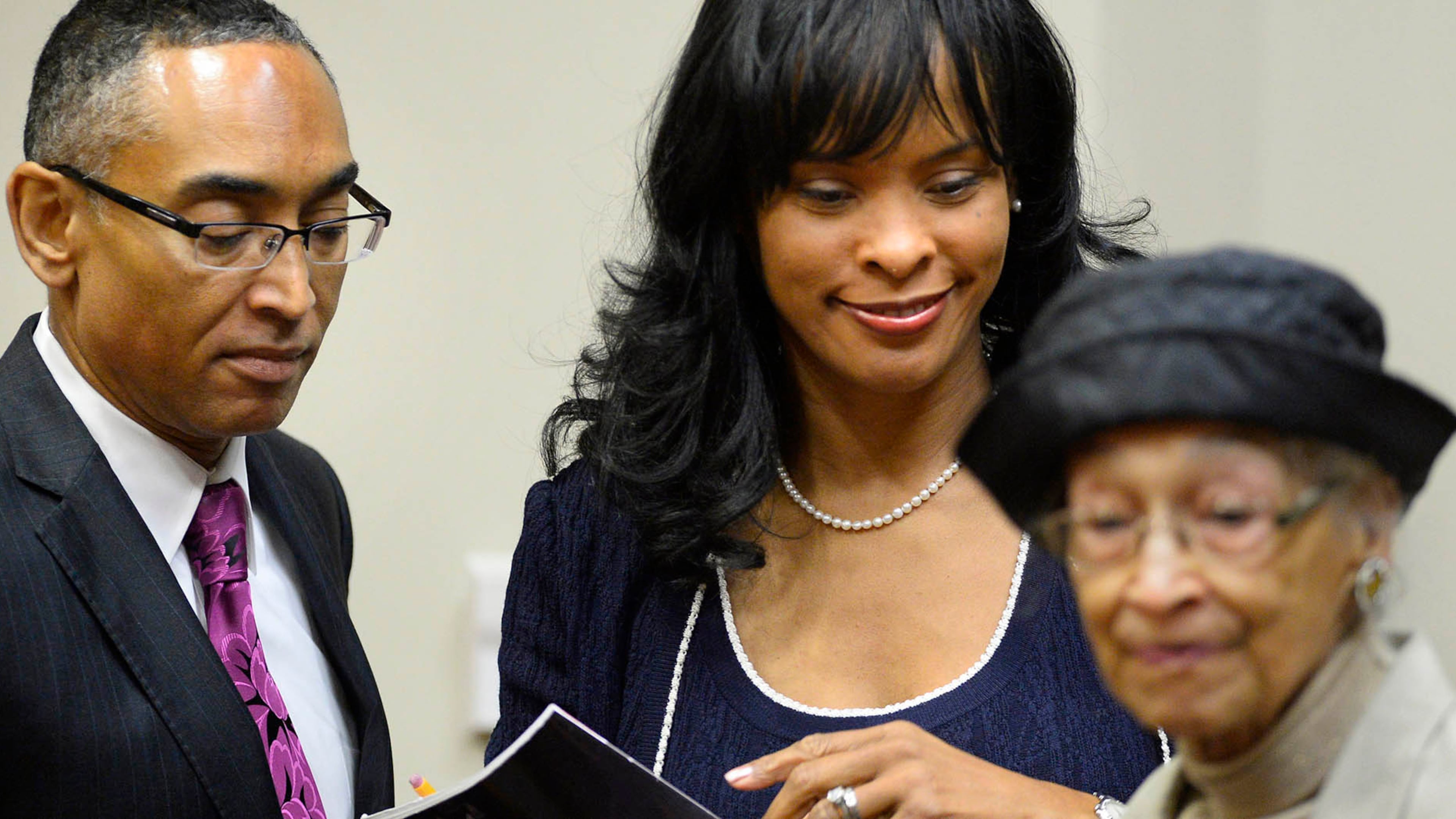 Suspended DeKalb County CEO Burrell Ellis, left, leaves court with his wife Philippa and mother Roberta, right, after documents were supplied to help jurors who are meeting for a 10th day of deliberations during a trial in DeKalb County Superior Court on Monday, Oct. 20, 2014 in Decatur, Ga. Ellis is accused of threatening contractors that resisted his requests for campaign contributions. David Tulis / AJC Special