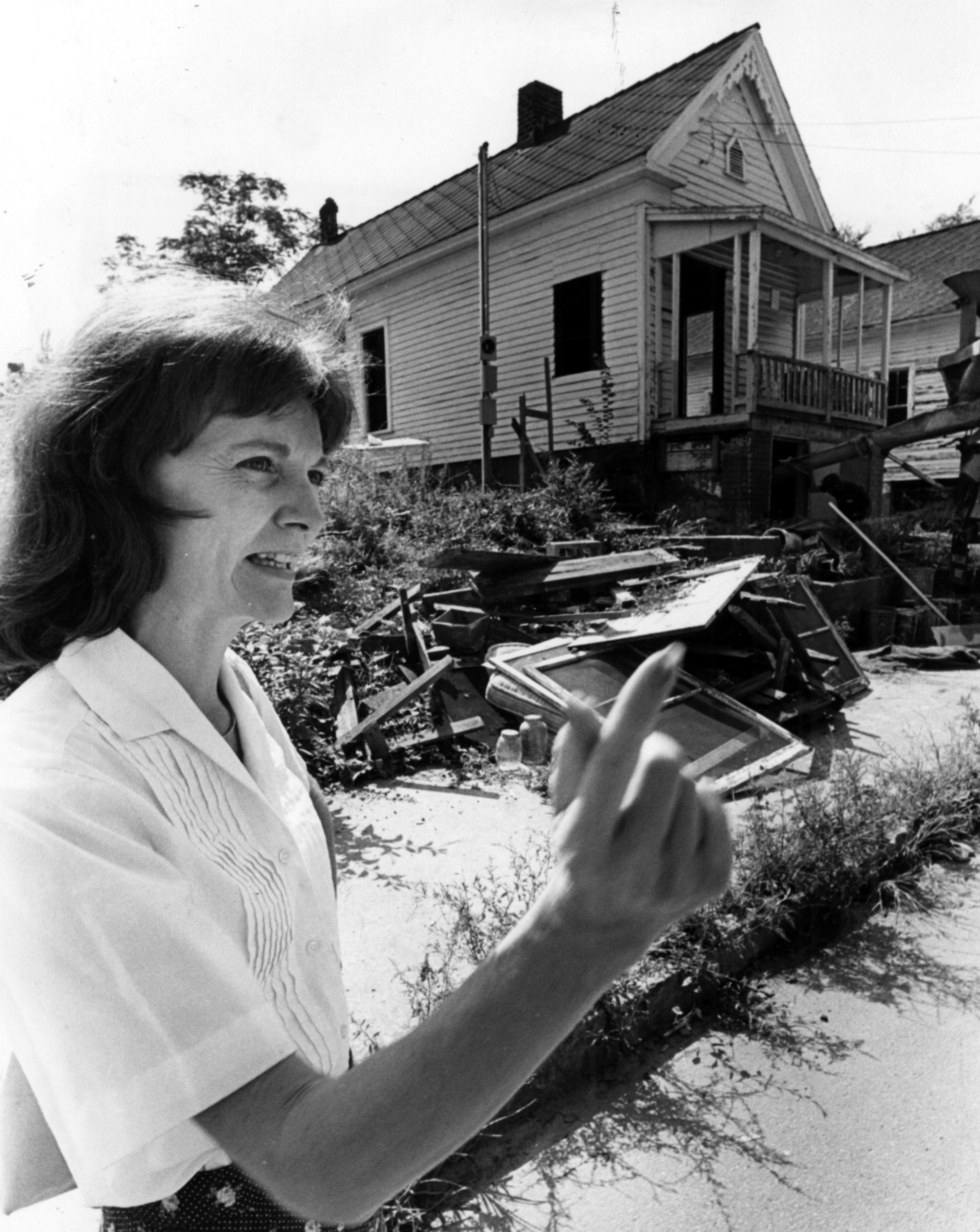 Aug. 5, 1980 - Priscilla House stands in front of the ramshackle Cabbagetown house on Savannah Street which she and her husband purchased as an investment for about $5,000. The house when renovated should be worth from $32,000-$36,000.