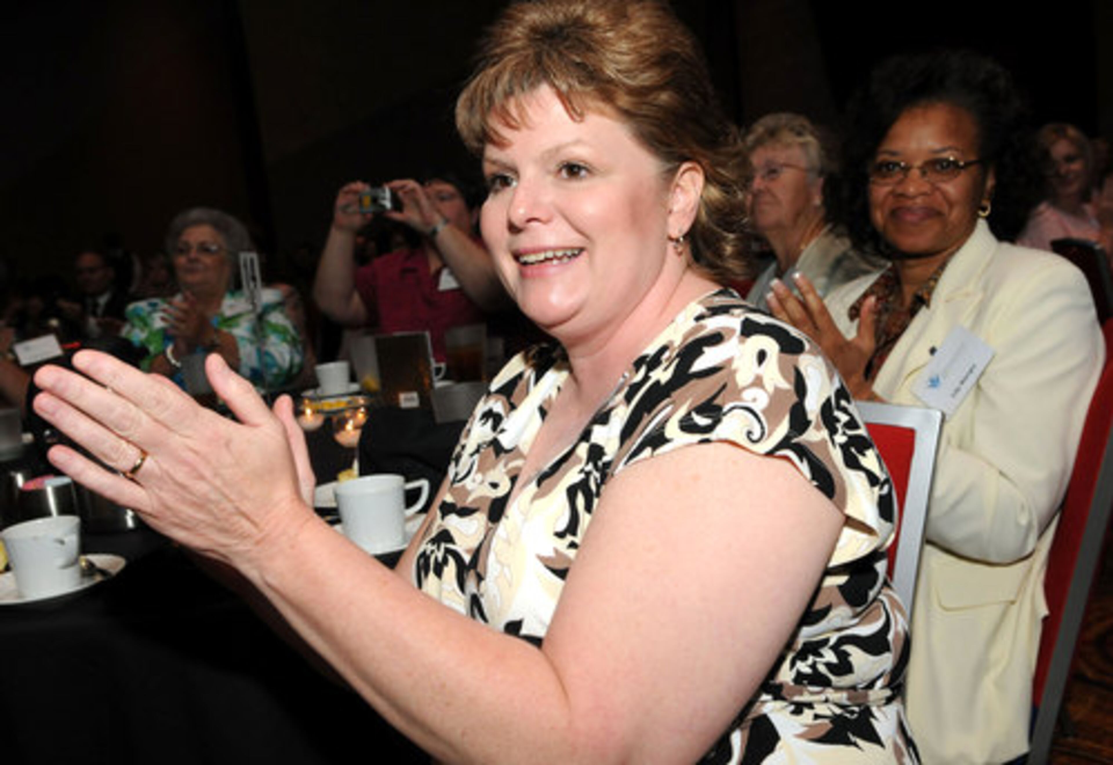 Teresa Fullington claps during the Celebrating Nurses Luncheon.