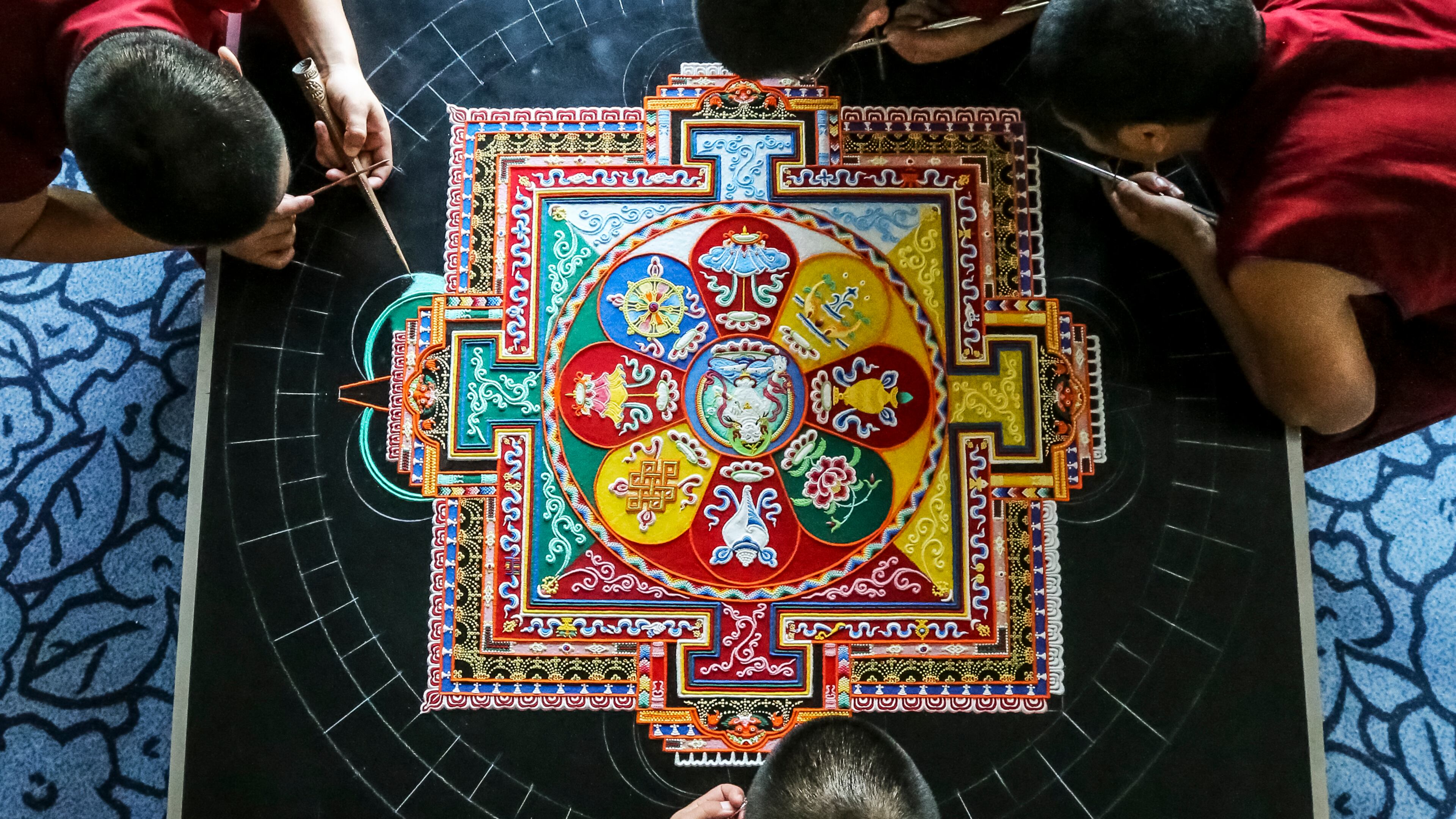 Left to right top - Tibetan monks, Sonam Gyatso, Lobsang Gyatso, Lobsang Tsering and Dorjee (bottom) continued Mandala Sand Painting on Thursday, March 23, 2017 at the Michael C. Carlos Museum as Emory University observes Tibet Week.