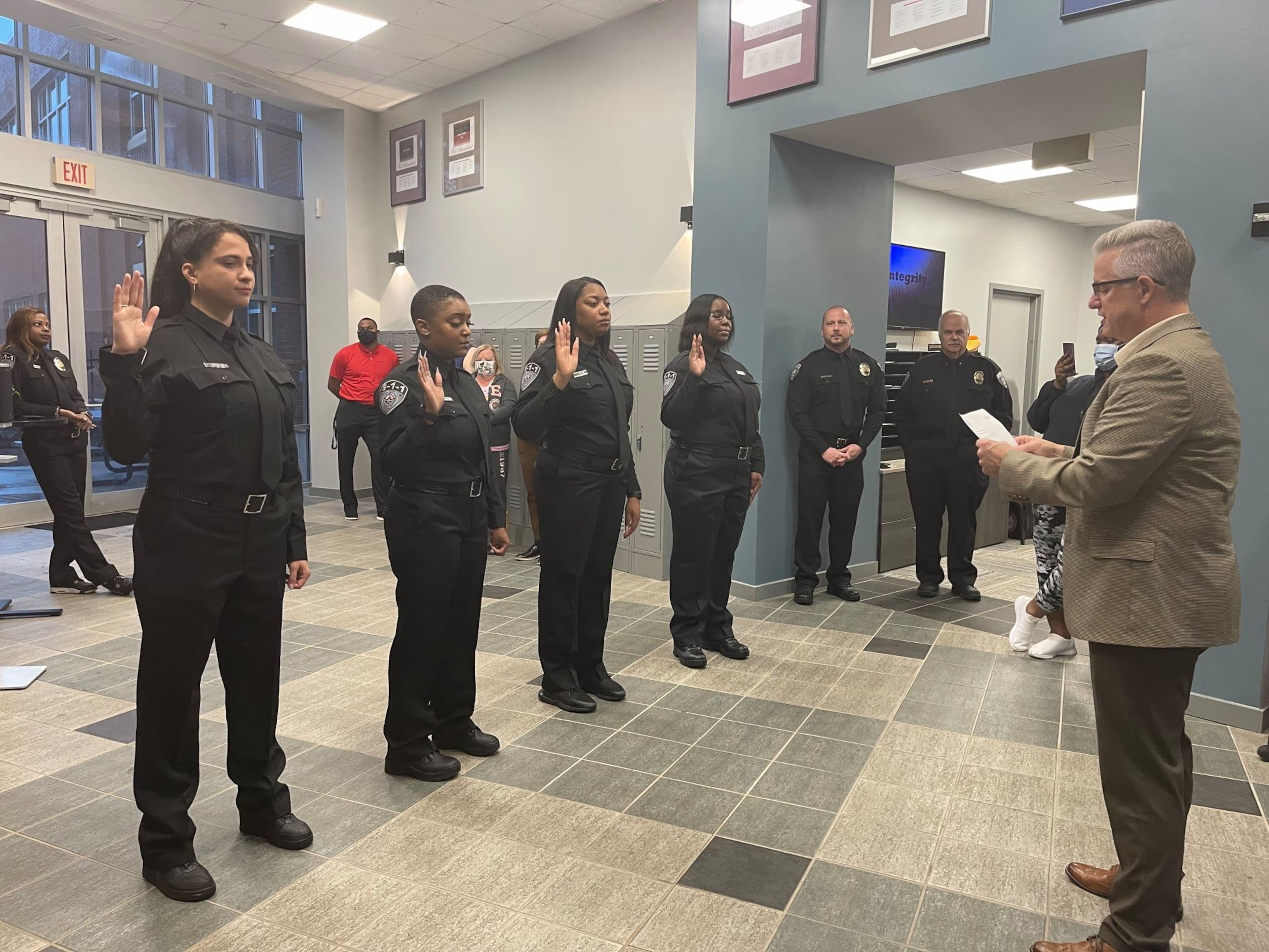John Robison, Alpharetta's director of public safety, swears in four 911 Communications Officers following their successful completion of training in 2021. (Courtesy of the city of Alpharetta)