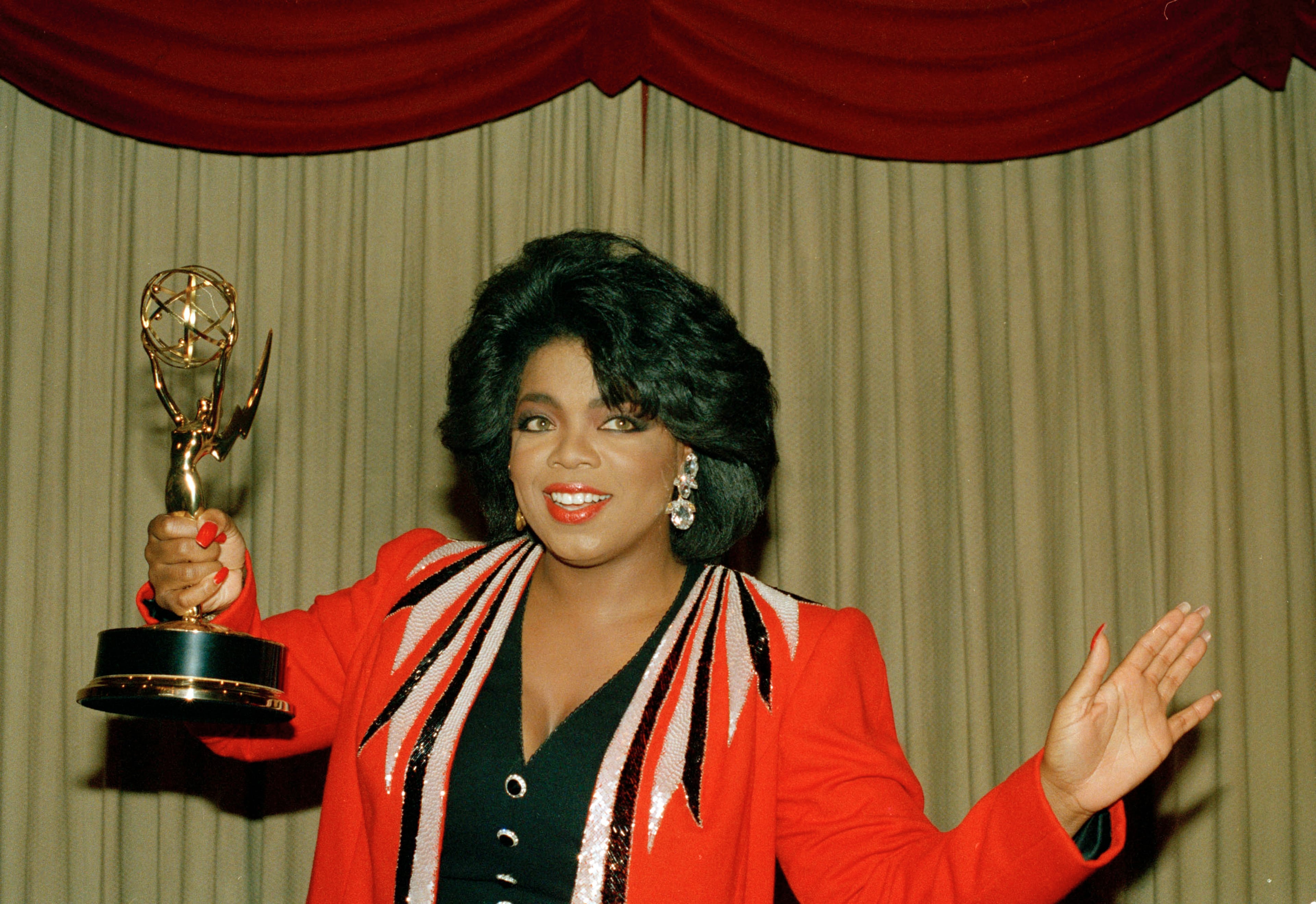 Television talk show host Oprah Winfrey shows off her Daytime Emmy award, 1987. (AP Photo)