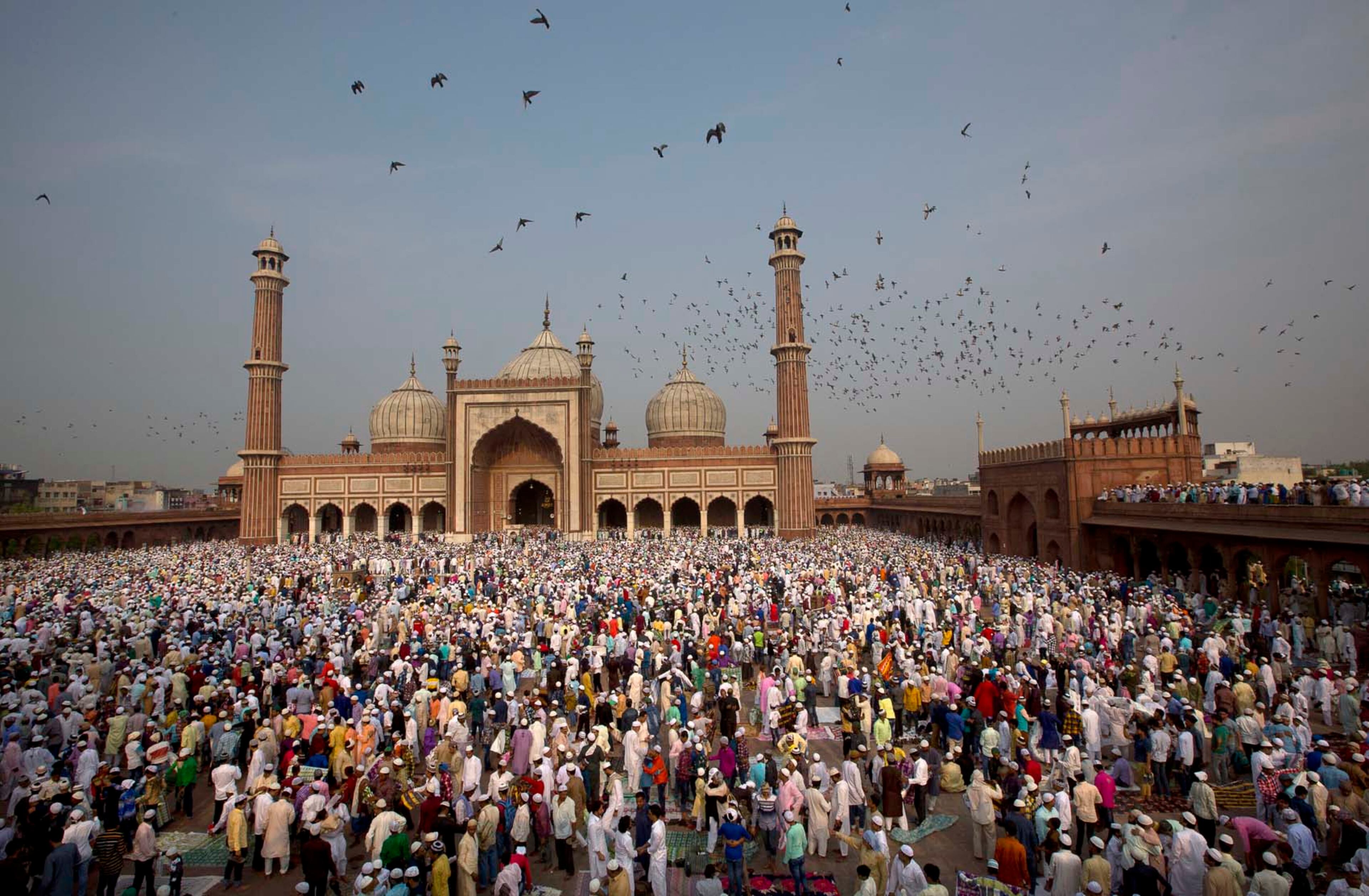 Muslims hug and greet each other after offering Eid al-Fitr prayers at the Jama Masjid Mosque in New Delhi, India, Monday, June 26, 2017. Eid al-Fitr marks the end of the Muslims' holy fasting month of Ramadan. (AP Photo/Manish Swarup)