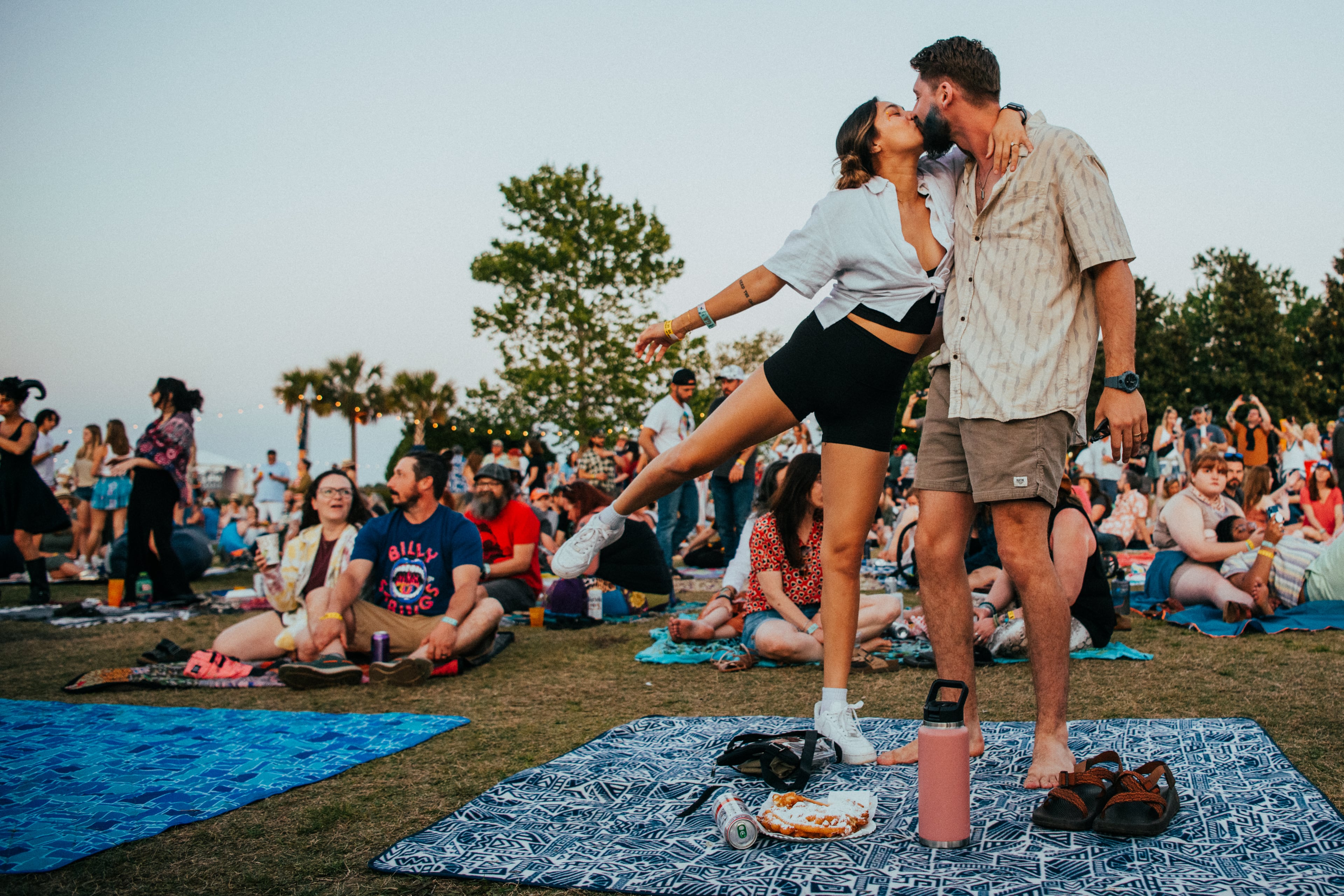 Couple at High Water Festival take a moment for a kiss. Photo by Charles Reagan.