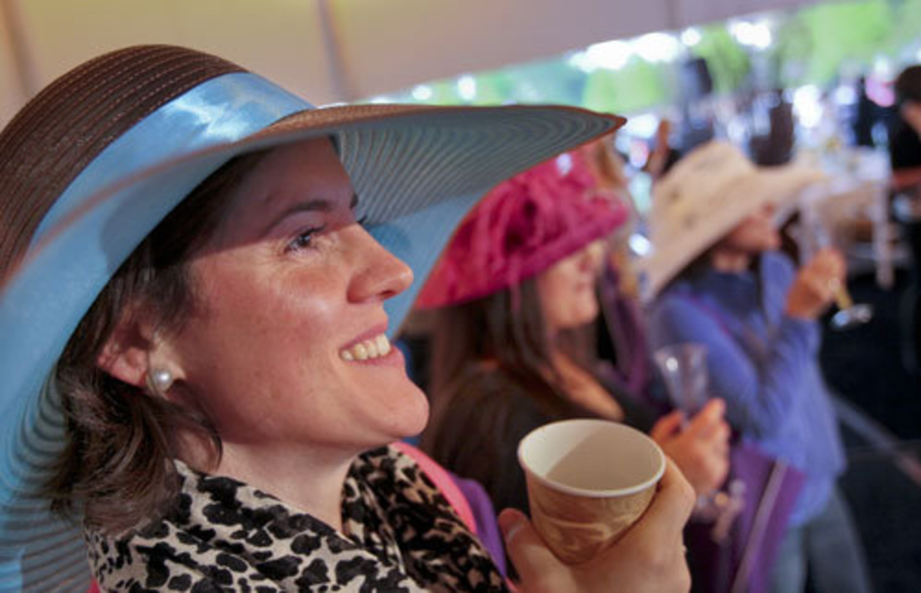 Sonia Davis, left, Heather Clay and Katrina Gammell sip their drinks and watch the event.
