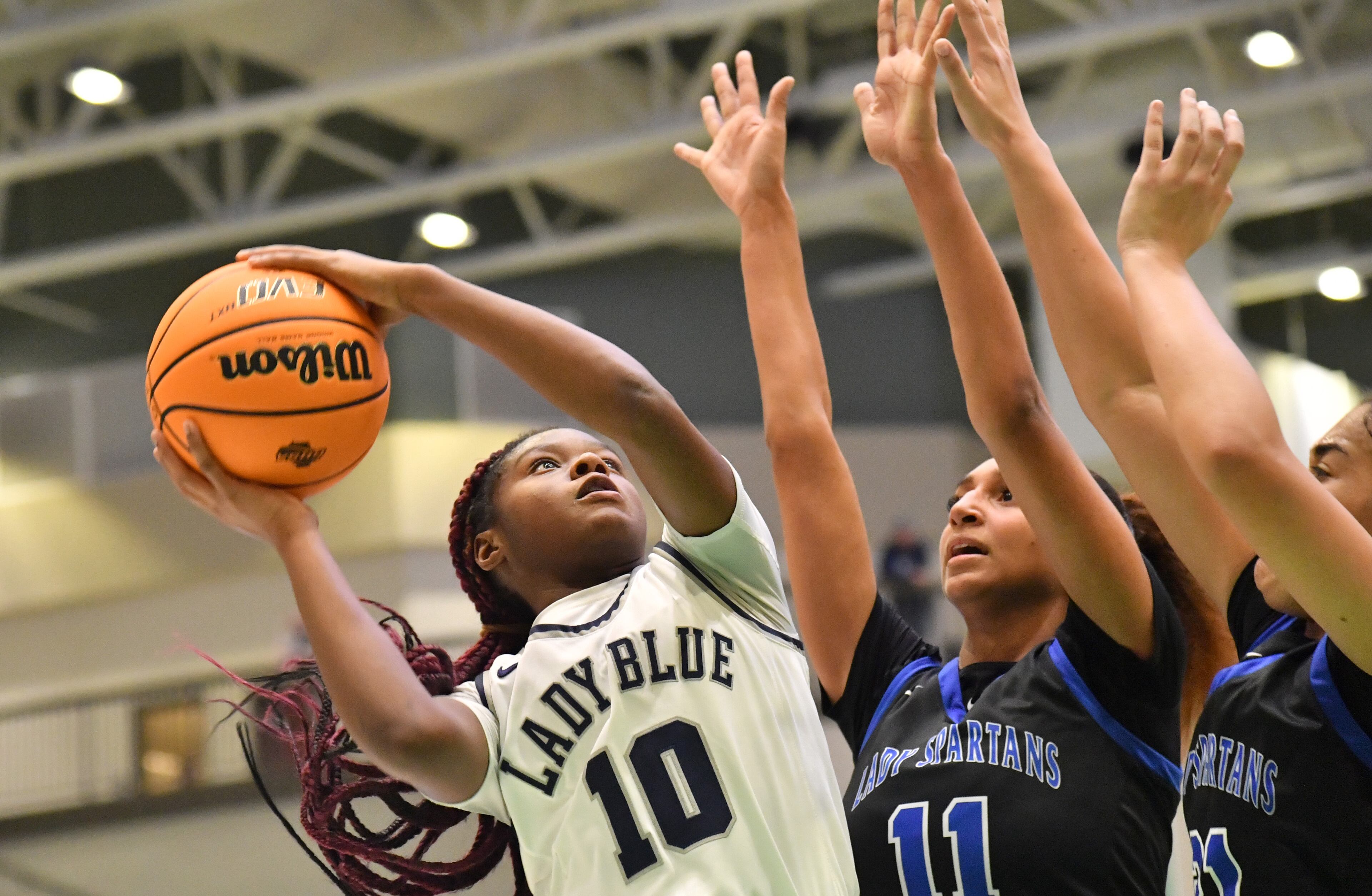 Norcross' Kayla Lindsey (10) shoots against Campbell's Cheyenne Clark (11) and Laila Battle (21) in the second half of 2022 GHSA Basketball Playoffs at Buford Arena on Friday, March 4, 2022. Norcross won 54-51 over Campbell. (Hyosub Shin / Hyosub.Shin@ajc.com)