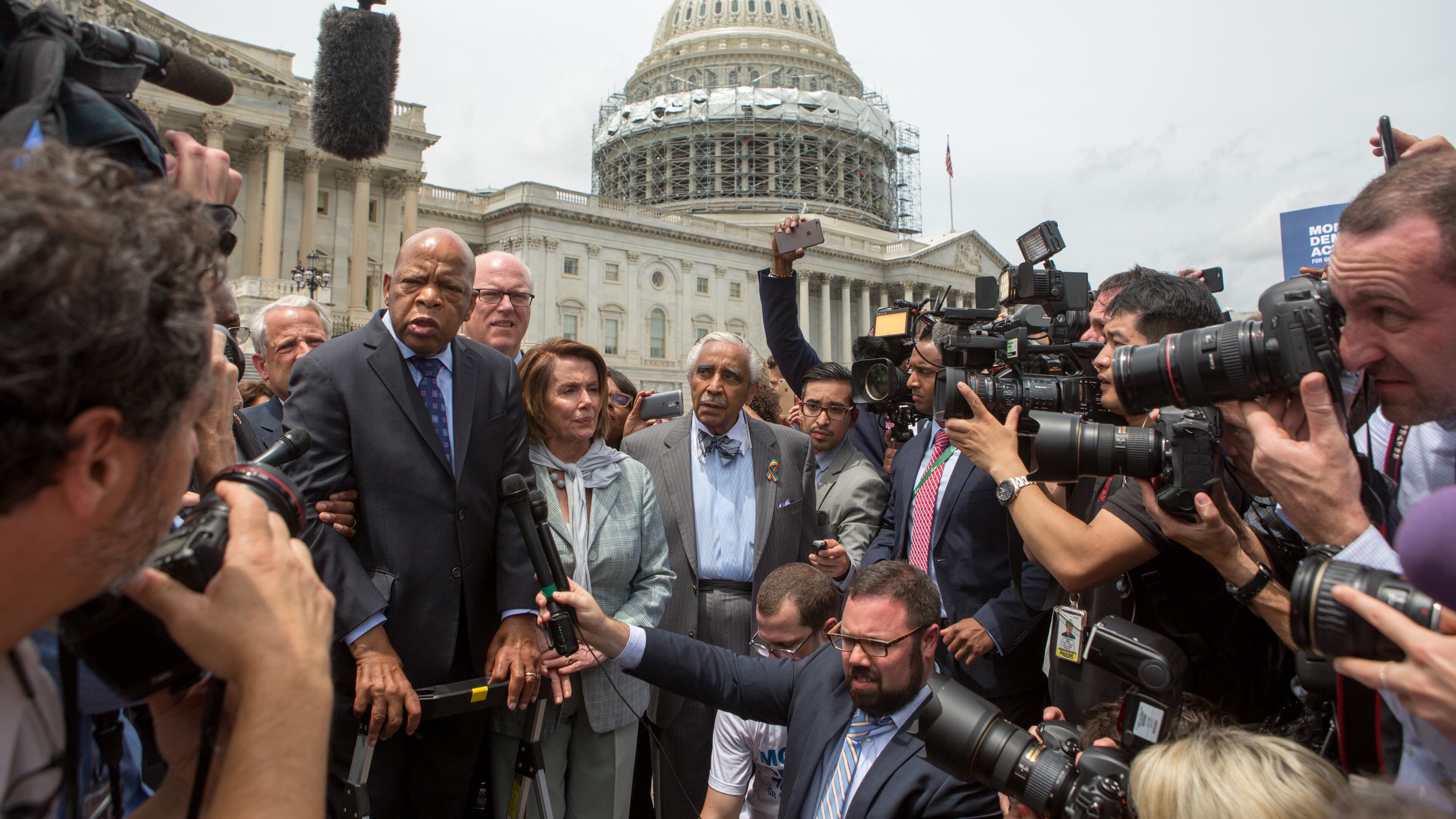 WASHINGTON, DC - JUNE 23: Rep. John Lewis (D-GA), left, Minority Leader Nancy Pelosi (D-CA), center, and Charles Rangel, (D-NY), right, speak with supporters outside the U.S. Capitol building June 23, 2016 in Washington, DC. Democratic House members ended their overnight House floor sit-in trying to force a vote on gun control legislation. (Photo by Allison Shelley/Getty Images)