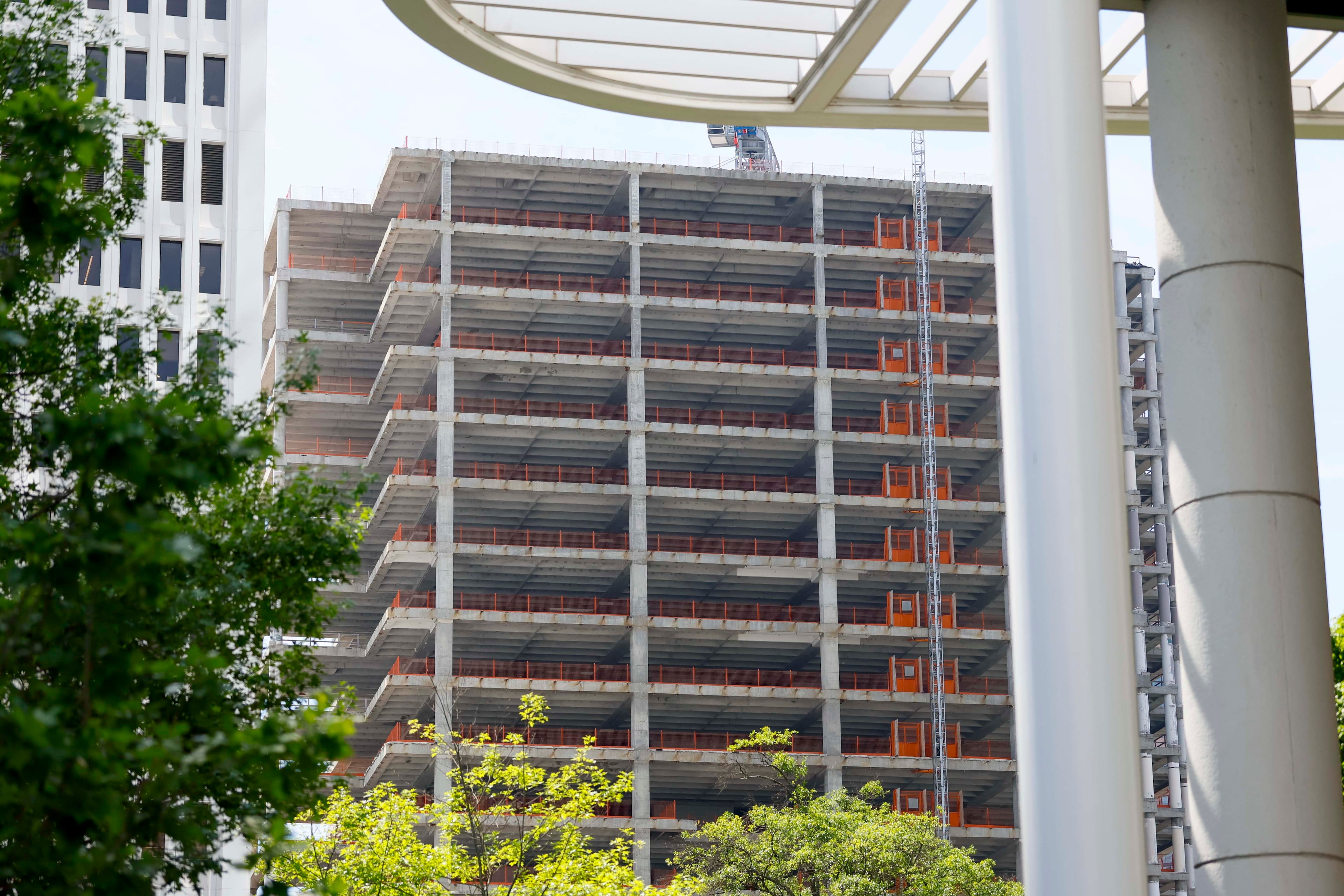 A section of the Campanile building can be seen from Peachtree Street NE and 14th Street on Tuesday, May 19, 2026. Dewberry Capital purchased the building in 2010, but little visible progress has been made since renovation began more than five years ago. (Miguel Martinez/AJC)