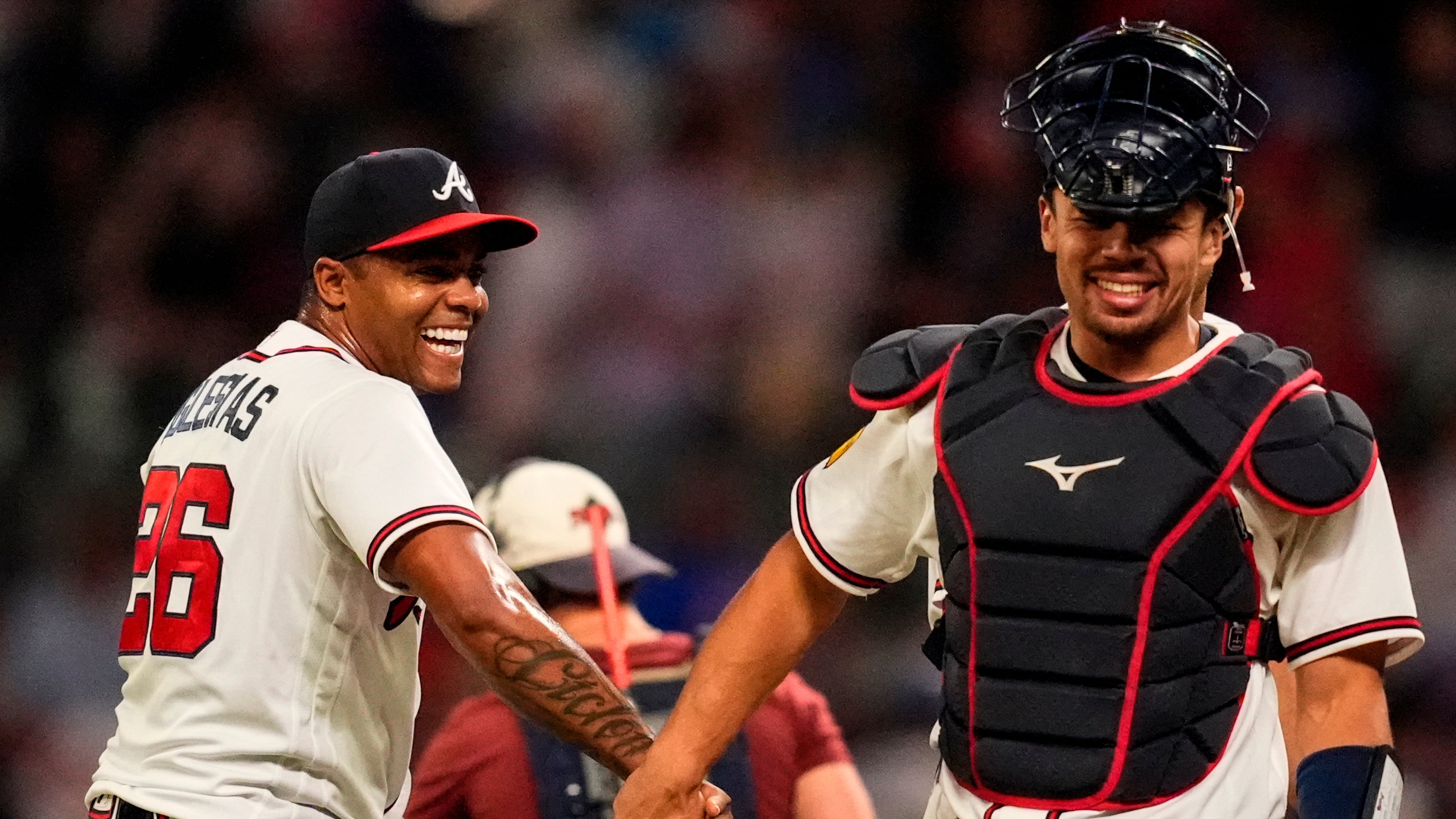 Atlanta Braves pitcher Raisel Iglesias celebrates a win over the Chicago Cubs with Drake Baldwin after a baseball game, Wednesday, May 13, 2026, in Atlanta. (AP Photo/Mike Stewart)