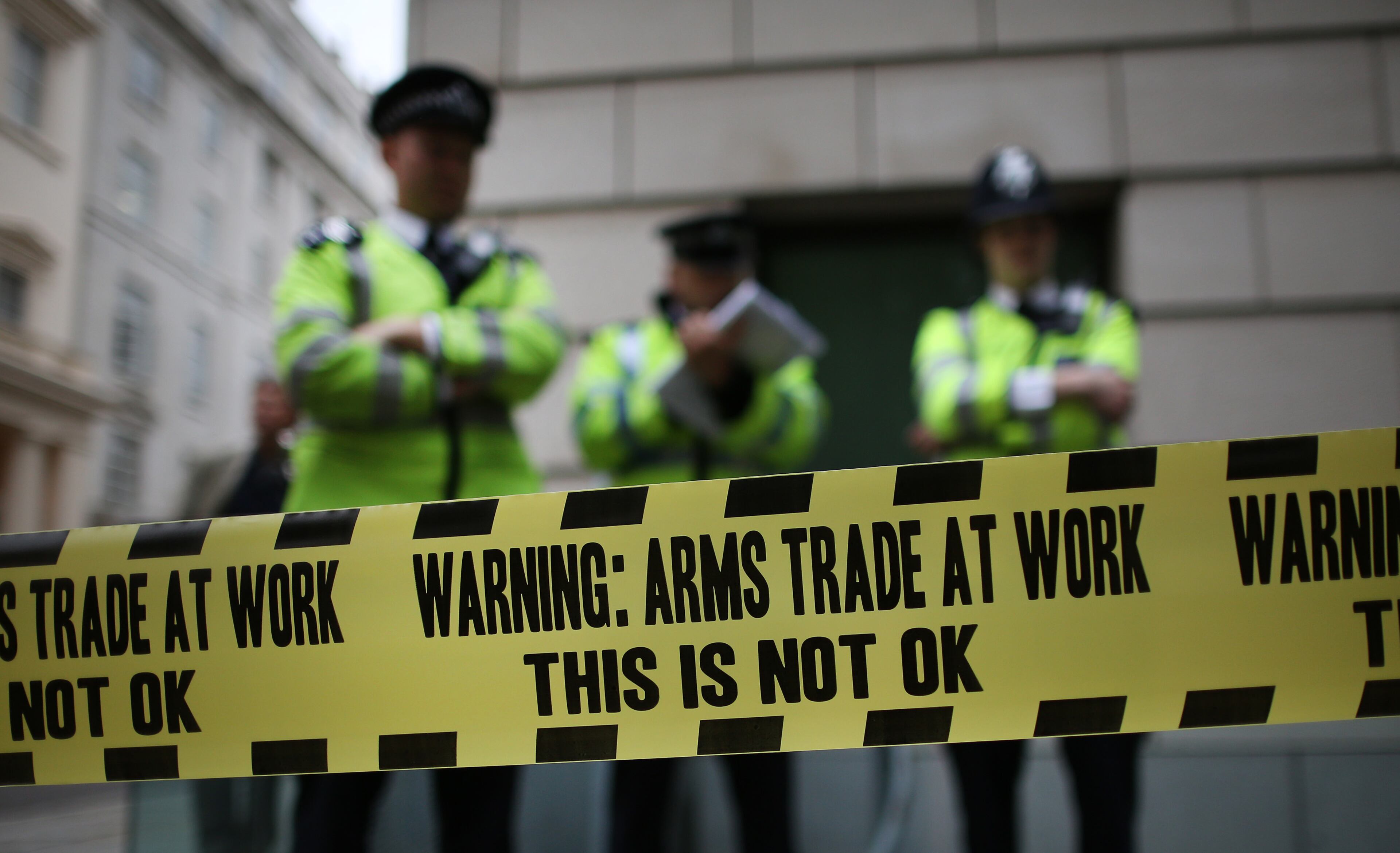 Police stand behind some anti-arms trade cordon tape during protests outside arms manufacturer BAe Systems on June 12, 2013 in London, England. Protests are expected to take place in London in the lead up to the G8 meeting to be held in Enniskillen, Northern Ireland on the 17 and 18 June 2013. The chosen location is only 8 kilometers from the scene of one of Northern Ireland's worst killings back in 1987, however Cameron is confident that it's secluded location will deter any potential trouble. (Photo by Peter Macdiarmid/Getty Images)