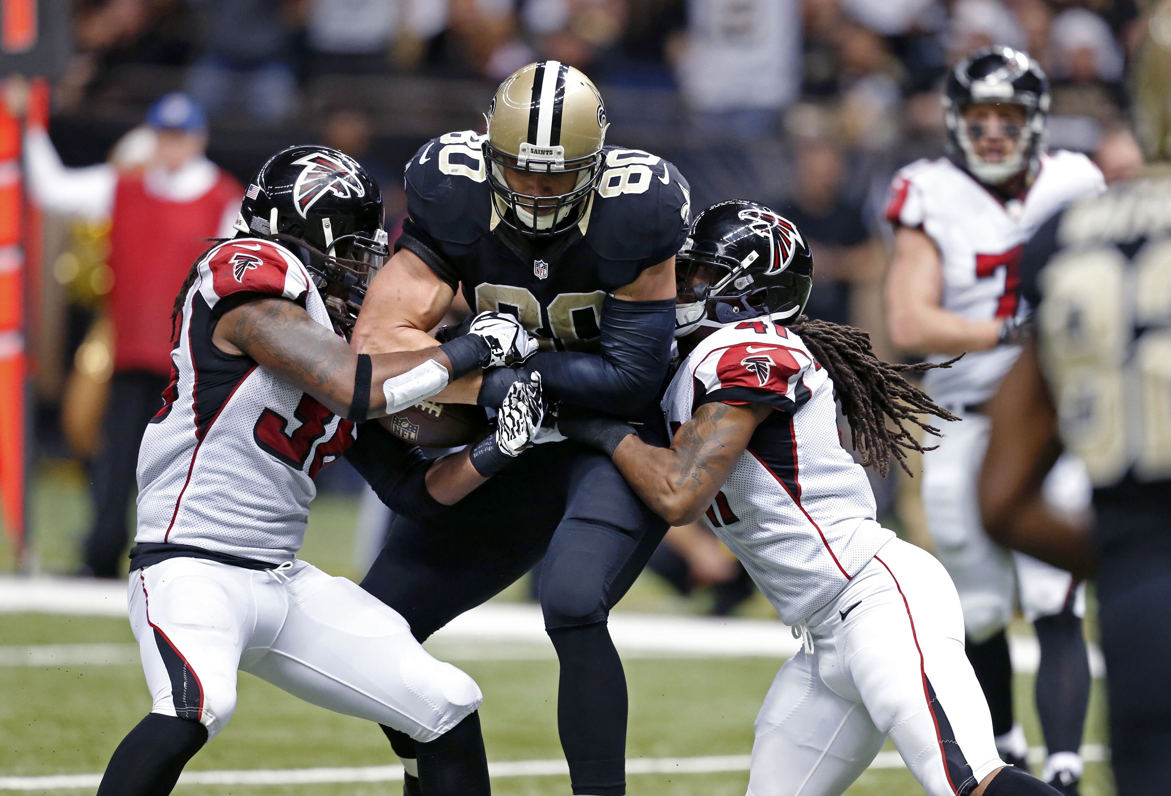 Atlanta Falcons strong safety Kemal Ishmael (36) strips the ball from New Orleans Saints tight end Jimmy Graham (80) after a reception at the goal line in the second half of an NFL football game in New Orleans, Sunday, Dec. 21, 2014. (AP Photo/Rogelio Solis)