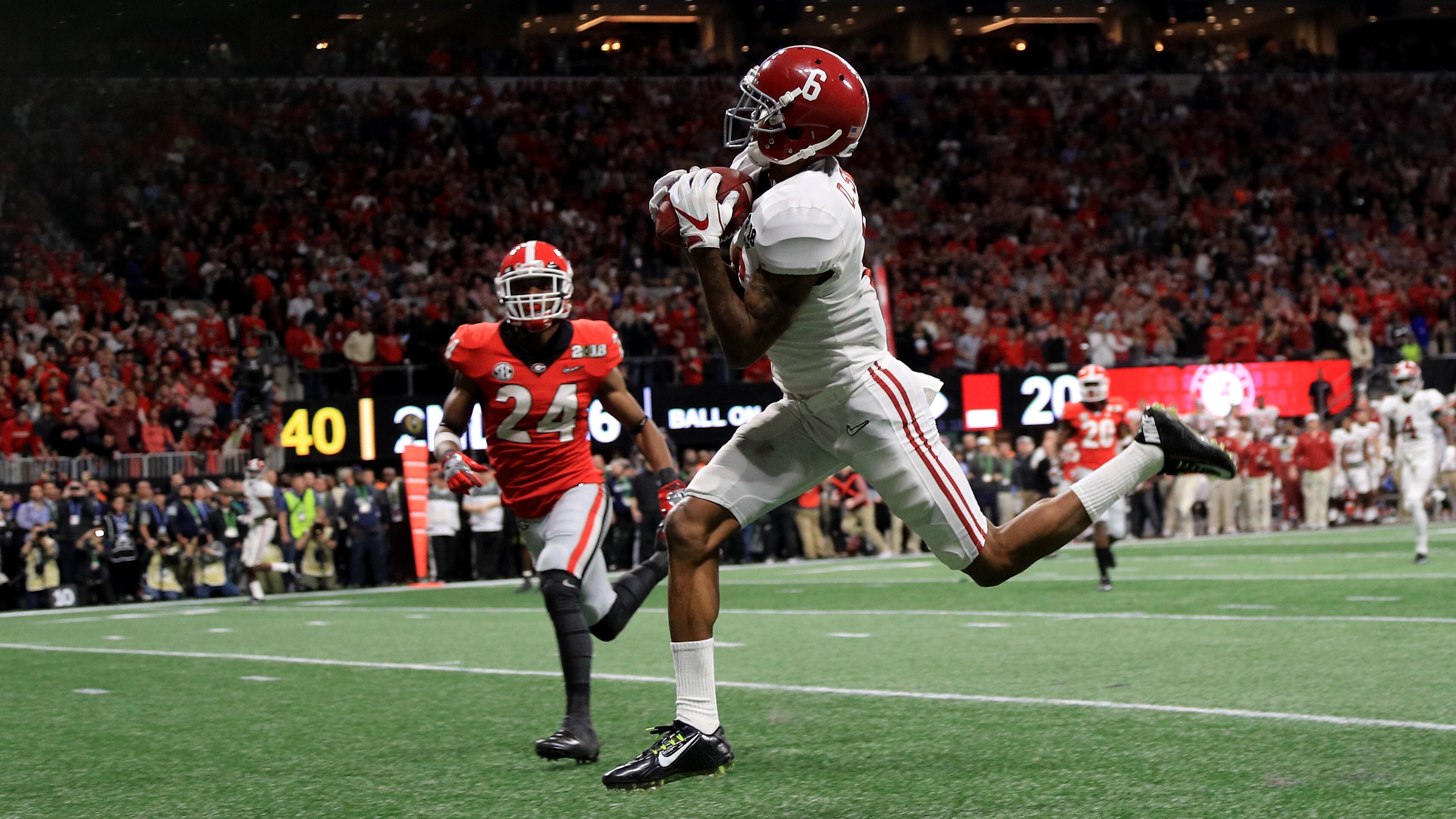 ATLANTA, GA - JANUARY 08: DeVonta Smith #6 of the Alabama Crimson Tide catches a 41 yard touchdown pass over Georgia saftey Dominick Sanders (24) to beat the Bulldogs in the CFP National Championship presented by AT&T in overtime at Mercedes-Benz Stadium on January 8, 2018 in Atlanta, Georgia. (Photo by Mike Ehrmann/Getty Images)