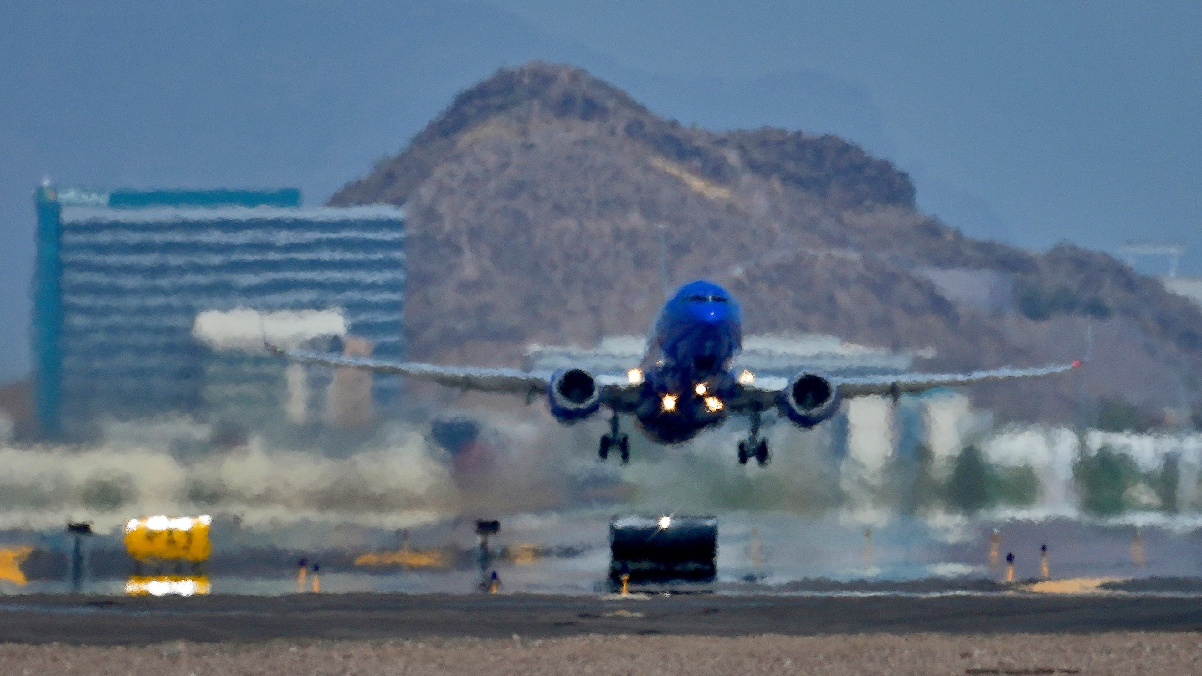 FILE - A jet takes flight as heat ripples radiate from the runway at Sky Harbor International Airport in Phoenix, on July 25, 2023. (AP Photo/Matt York, File)