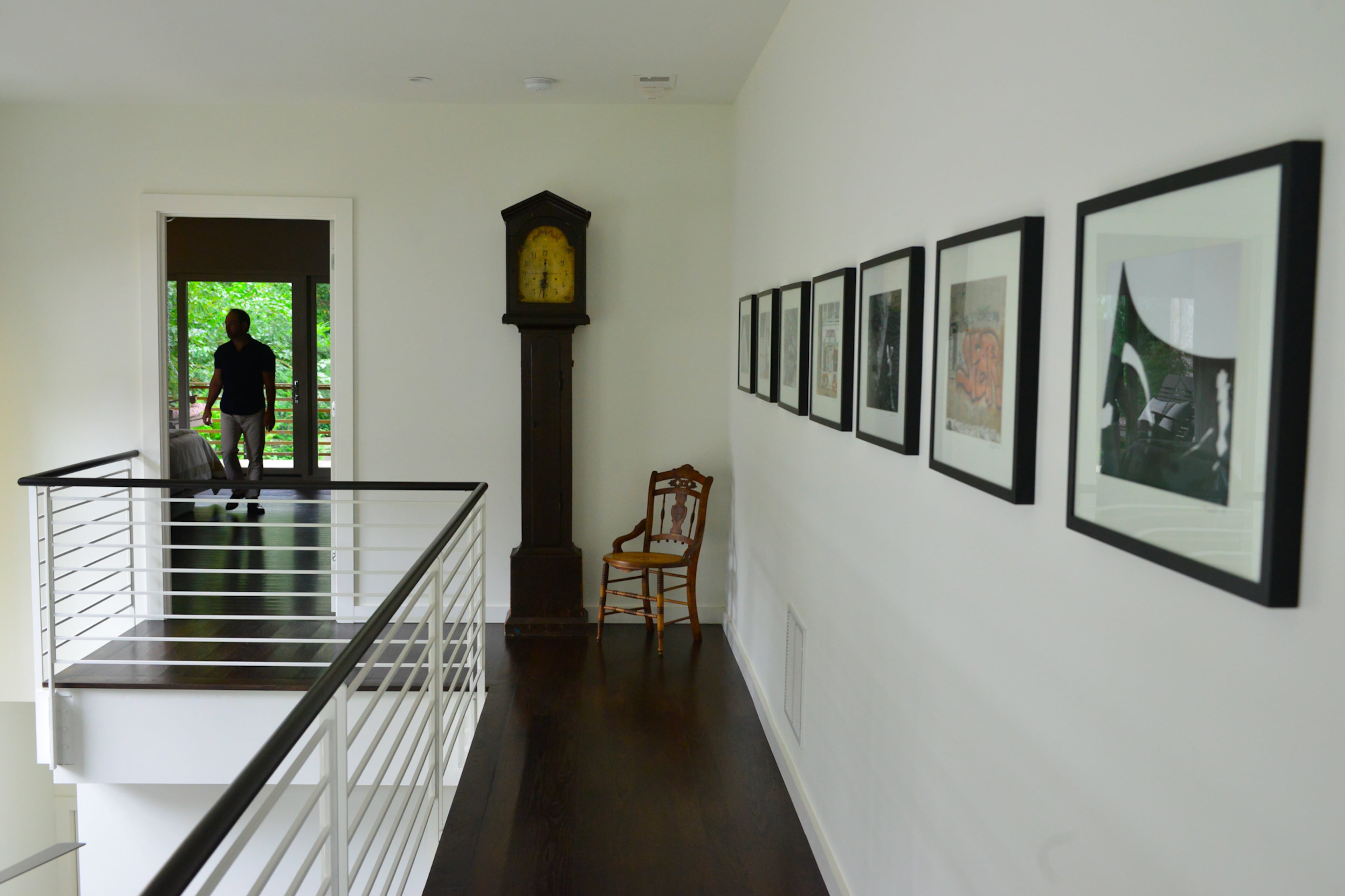 A grandfather clock in the catwalk has been in John Carroll's family since the 1800s. The Old Fourth Ward home mixes modern and antique furnishings and accessories to keep the home warm and interesting, the owners said.
