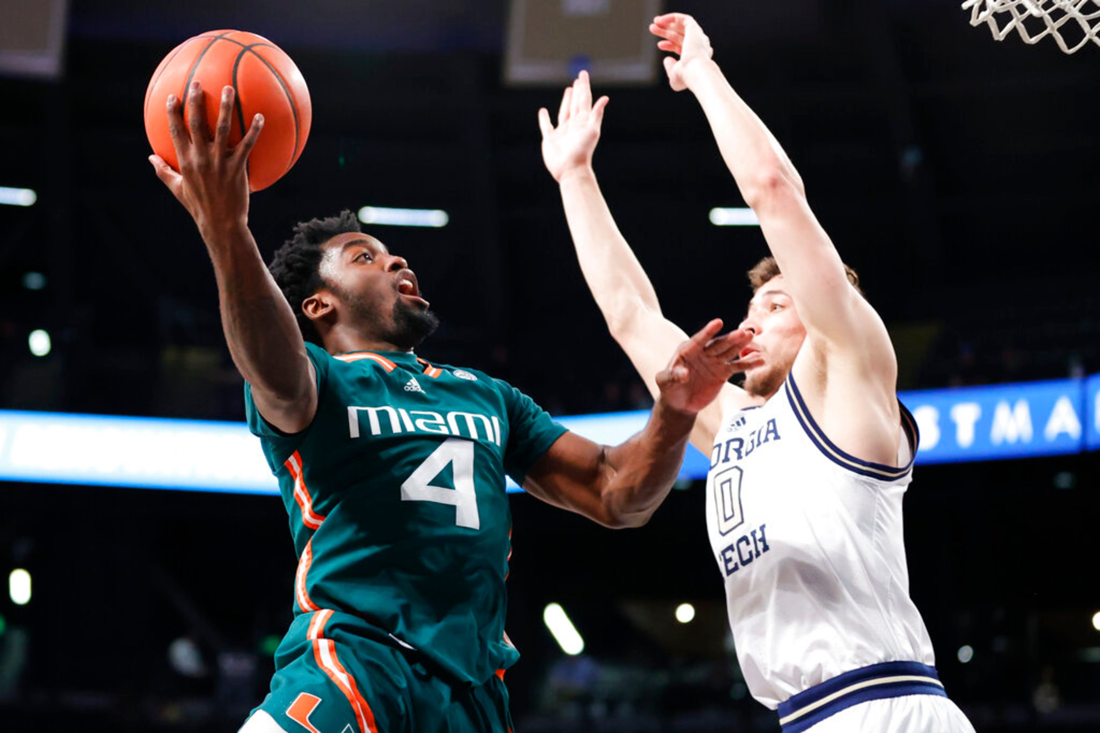 Miami guard Bensley Joseph, left, shoots against Georgia Tech guard Lance Terry during the second half of an NCAA college basketball game Wednesday, Jan. 4, 2023, in Atlanta. Georgia Tech beat Miami 76-70. (AP Photo/Alex Slitz)