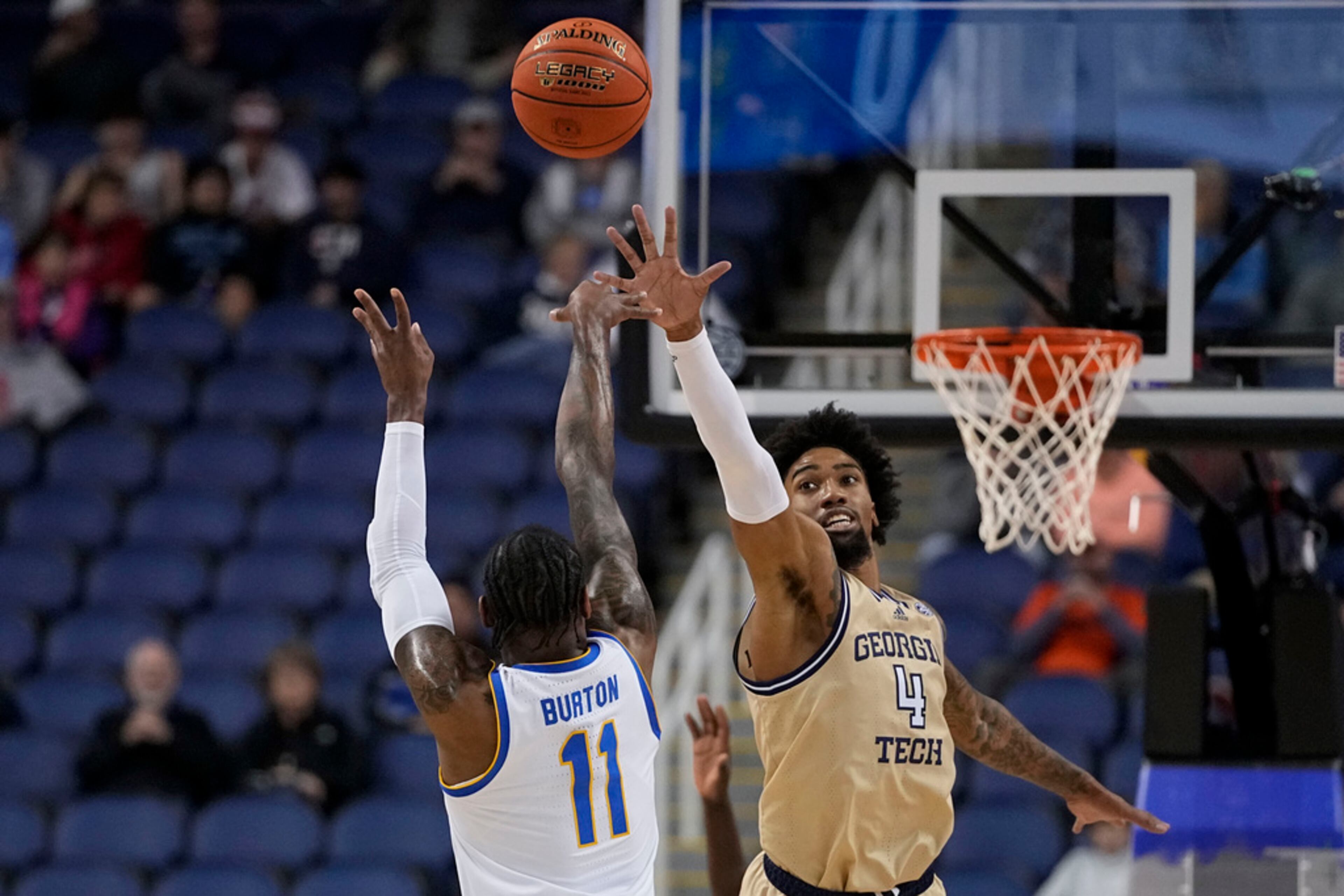 Pittsburgh guard Jamarius Burton shoots over Georgia Tech forward Javon Franklin during the first half of an NCAA college basketball game at the Atlantic Coast Conference Tournament, Wednesday, March 8, 2023, in Greensboro, N.C. (AP Photo/Chris Carlson)