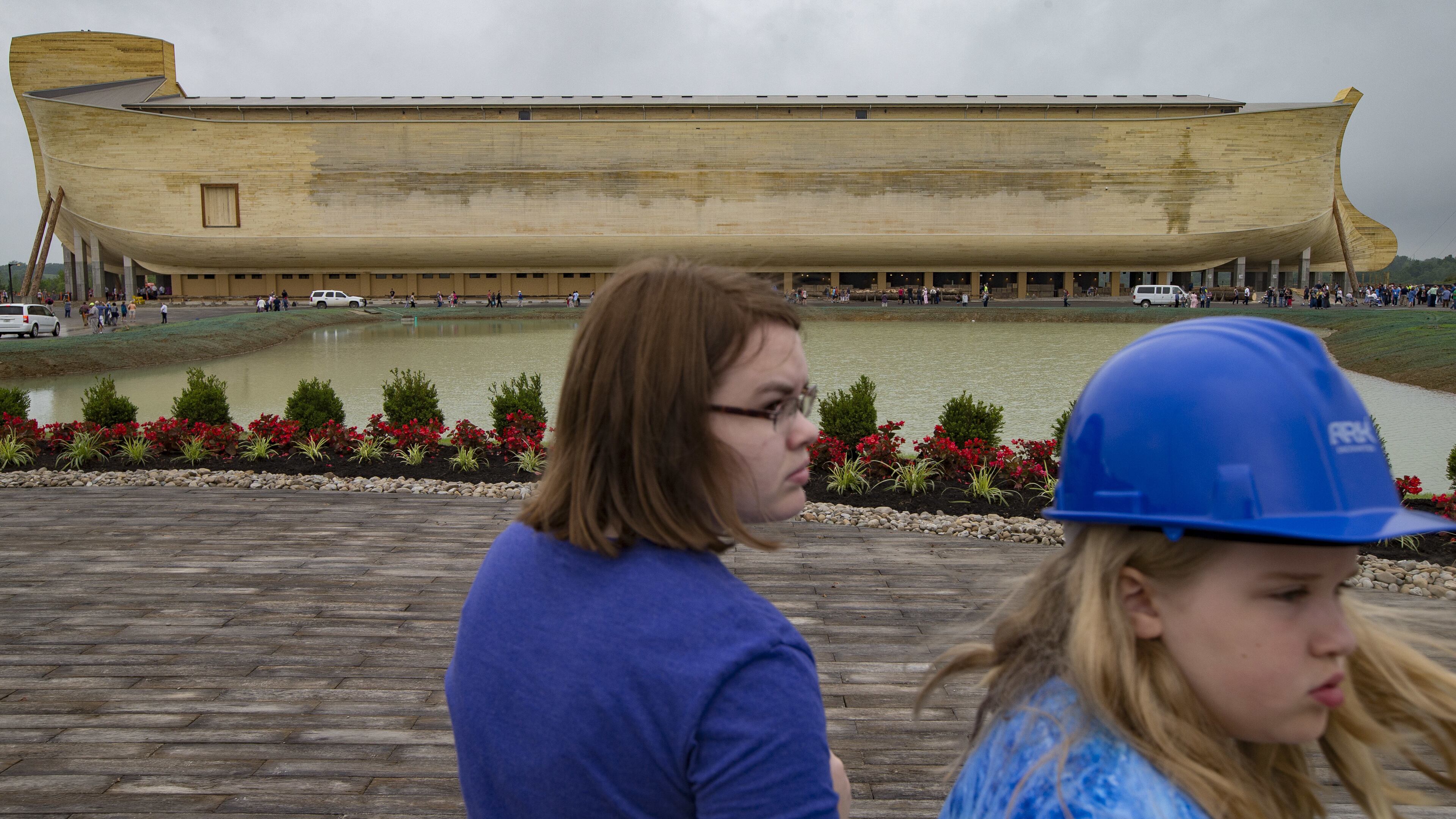 Visitors roam the Ark Encounter theme park as a replica of Noah’s Ark stands in the distance during a media preview day, Tuesday, July 5, 2016, in Williamstown, Ky. The long-awaited theme park based on the story of a man who got a warning from God about a worldwide flood will debut in central Kentucky this Thursday. The Christian group behind the 510 foot-long wooden ark says it will demonstrate that the stories of the Bible are true. Its construction has rankled opponents who say the attraction will be detrimental to science education. (AP Photo/John Minchillo)