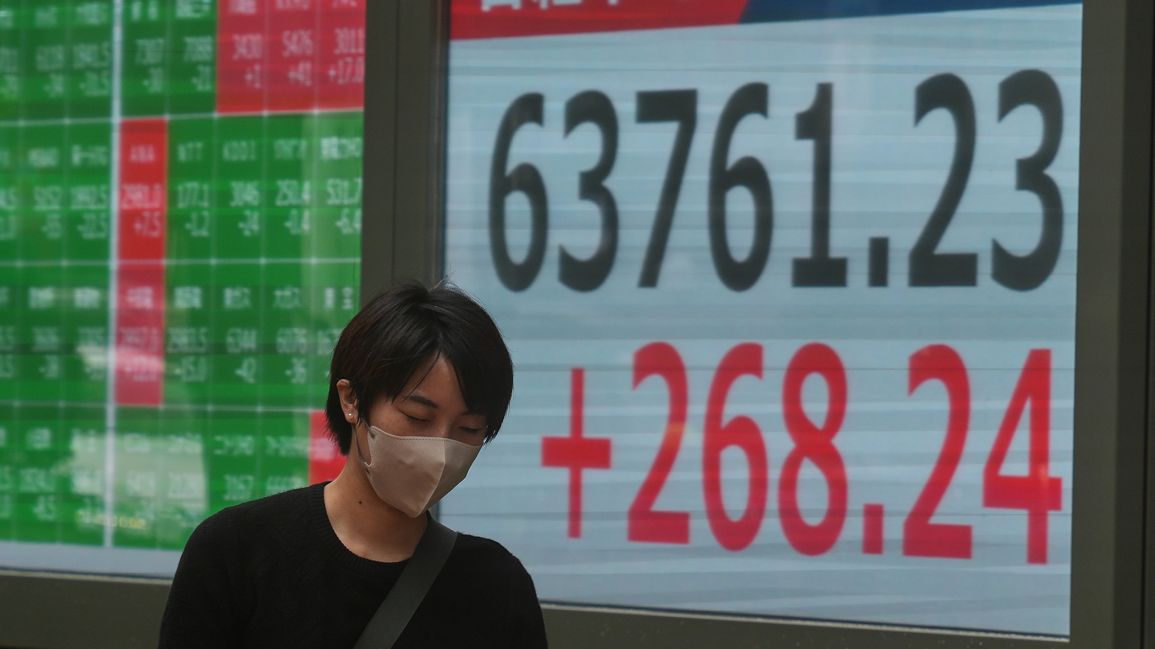 A person walks in front of an electronic stock board showing Japan's Nikkei index at a securities firm Tuesday, Sept. 15, 2026, in Tokyo. (AP Photo/Eugene Hoshiko)