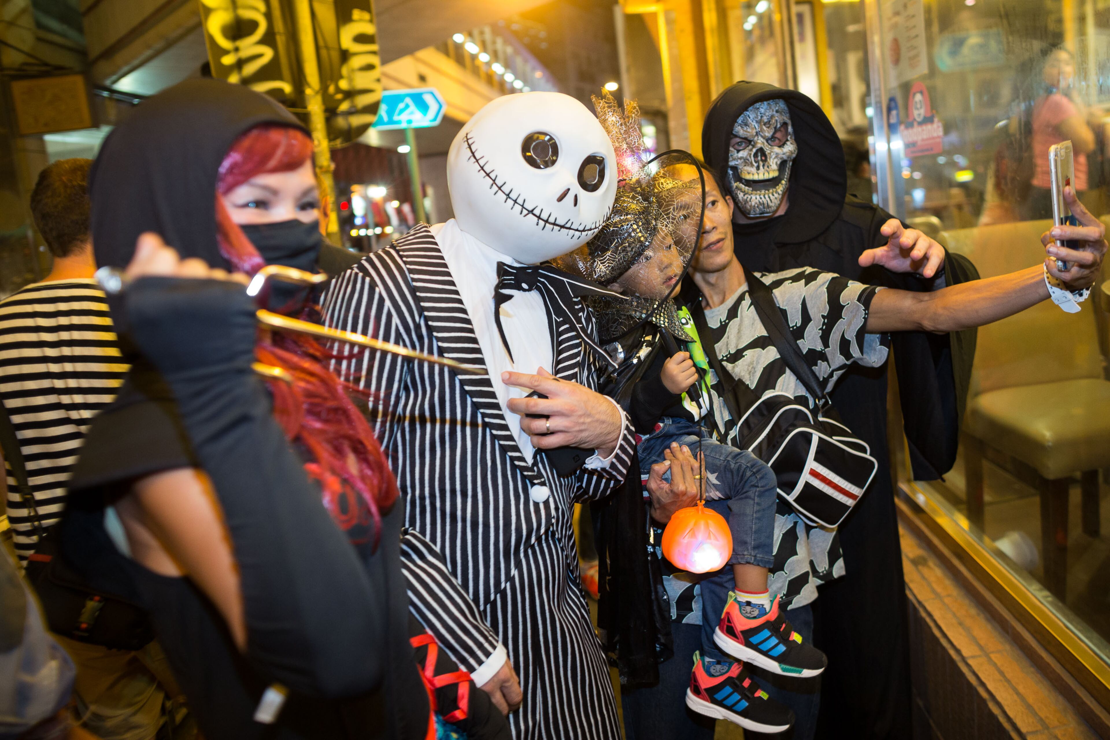 HONG KONG - OCTOBER 31: People in costume take photos during a Halloween event on October 31, 2015 in Lan Kwai Fong, Central District, Hong Kong. Halloween, a named taken from 'All Hallows' Even' falls on the day before All Saints' Day on November 1, a holiday when Christians remember their deceased loved ones. (Photo by Jerome Favre/Getty Images)