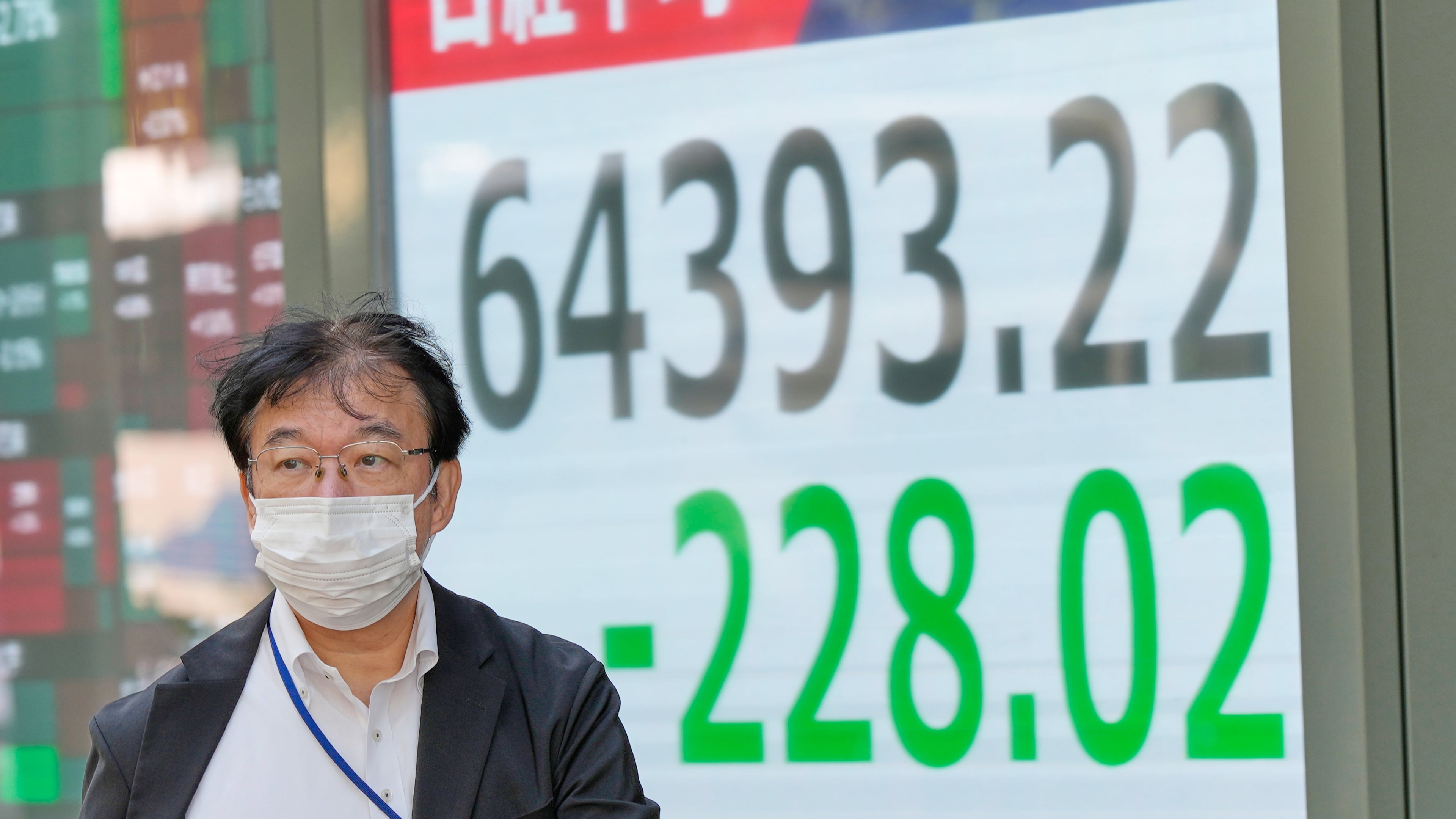 A person walks in front of an electronic stock board showing Japan's Nikkei index at a securities firm Thursday, Oct. 22, 2026, in Tokyo. (AP Photo/Eugene Hoshiko)