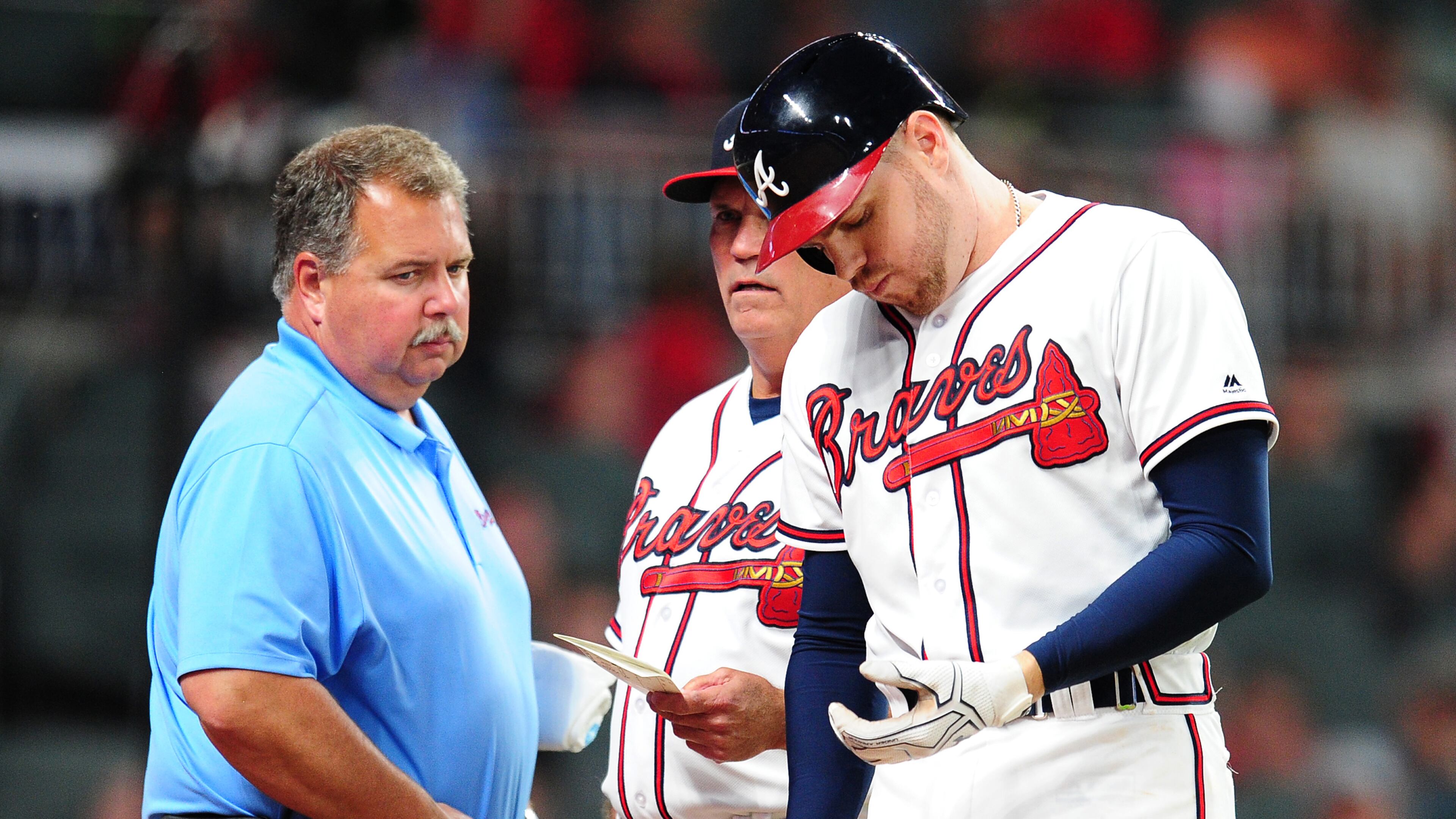 ATLANTA, GA - MAY 17: Freddie Freeman #5 of the Atlanta Braves is removed by Manager Brian Snitker #43 as trainer Jim Lovell watches after being hit by a fifth inning pitch against the Toronto Blue Jays at SunTrust Park on May 17, 2017 in Atlanta, Georgia. (Photo by Scott Cunningham/Getty Images)