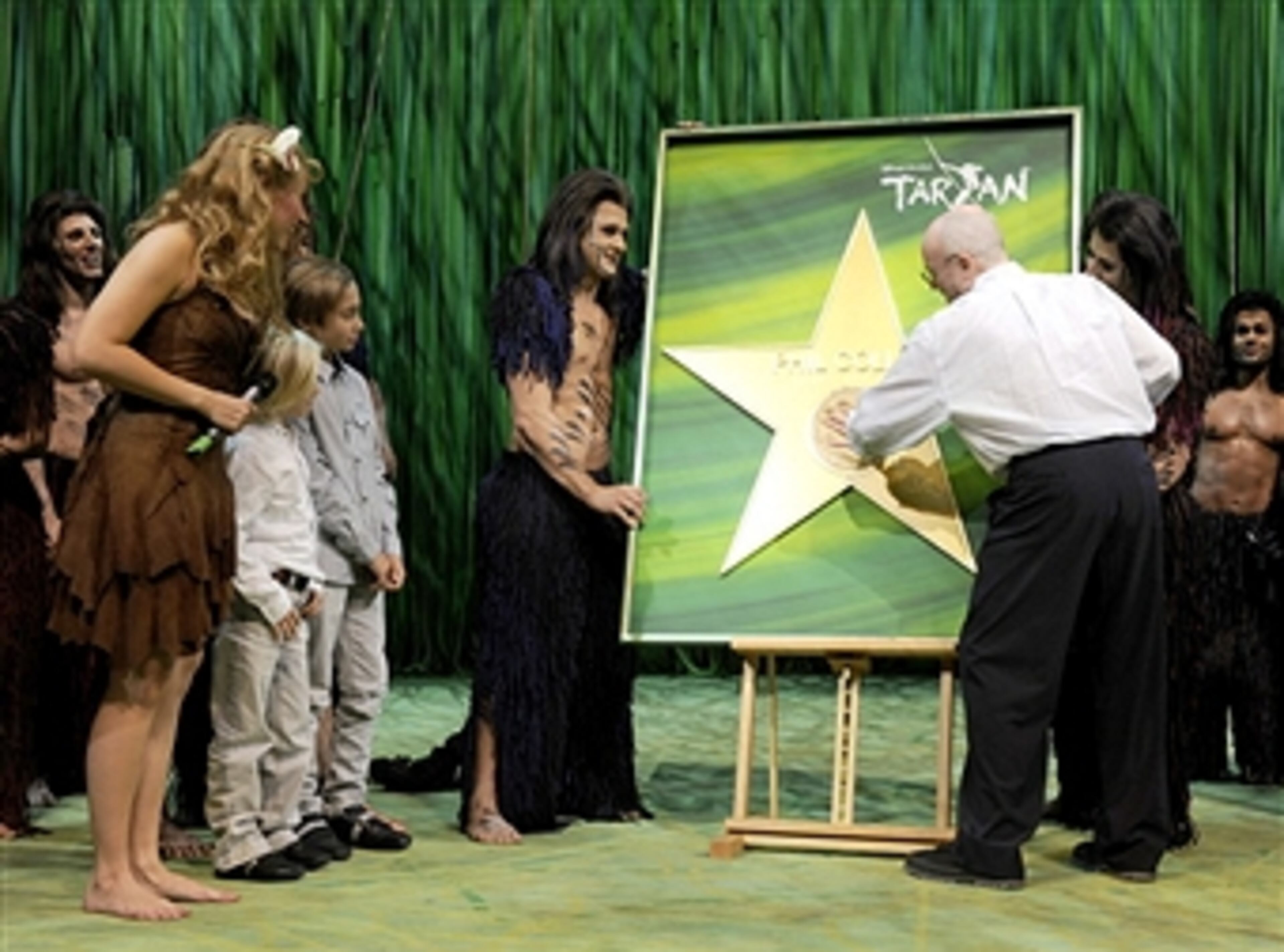 HAMBURG, GERMANY - OCTOBER 22: Phil Collins and both sons Matthew Collins and Nicholas Collins, Elisabeth Huebert (Jane) and Alexander Klaws are watching a handprint honouring Phil Collins during Tarzan Musical 3rd anniversary at Theatre 'Neue Flora' on October 22, 2011 in Hamburg, Germany. (Photo by Christian Augustin/Getty Images)