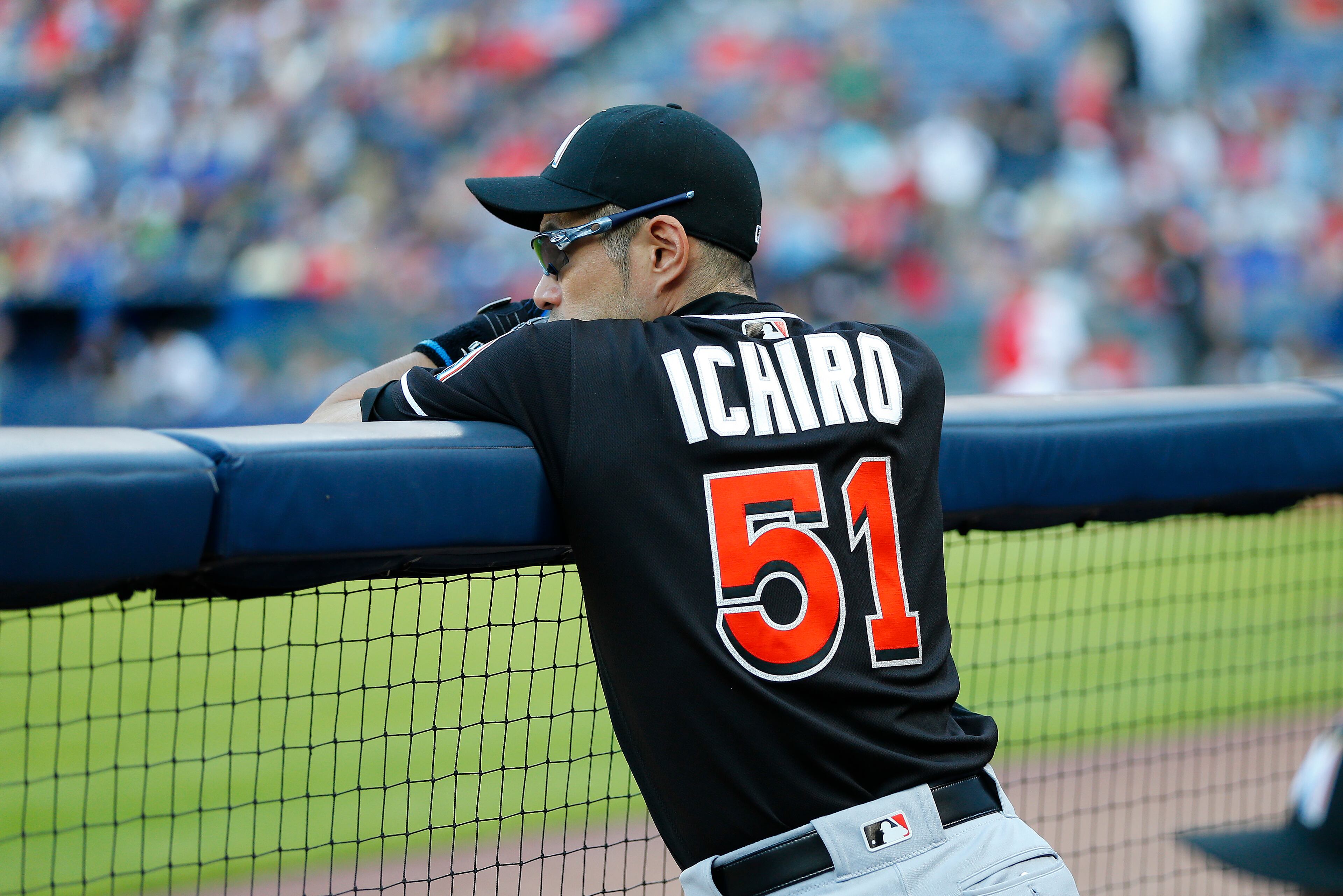 Miami Marlins center fielder Ichiro Suzuki (51) watches from the dugout in the first inning of a baseball game against the Atlanta Braves, Friday, July 1, 2016, in Atlanta. Suzuki was not in the starting lineup. (AP Photo/John Bazemore)