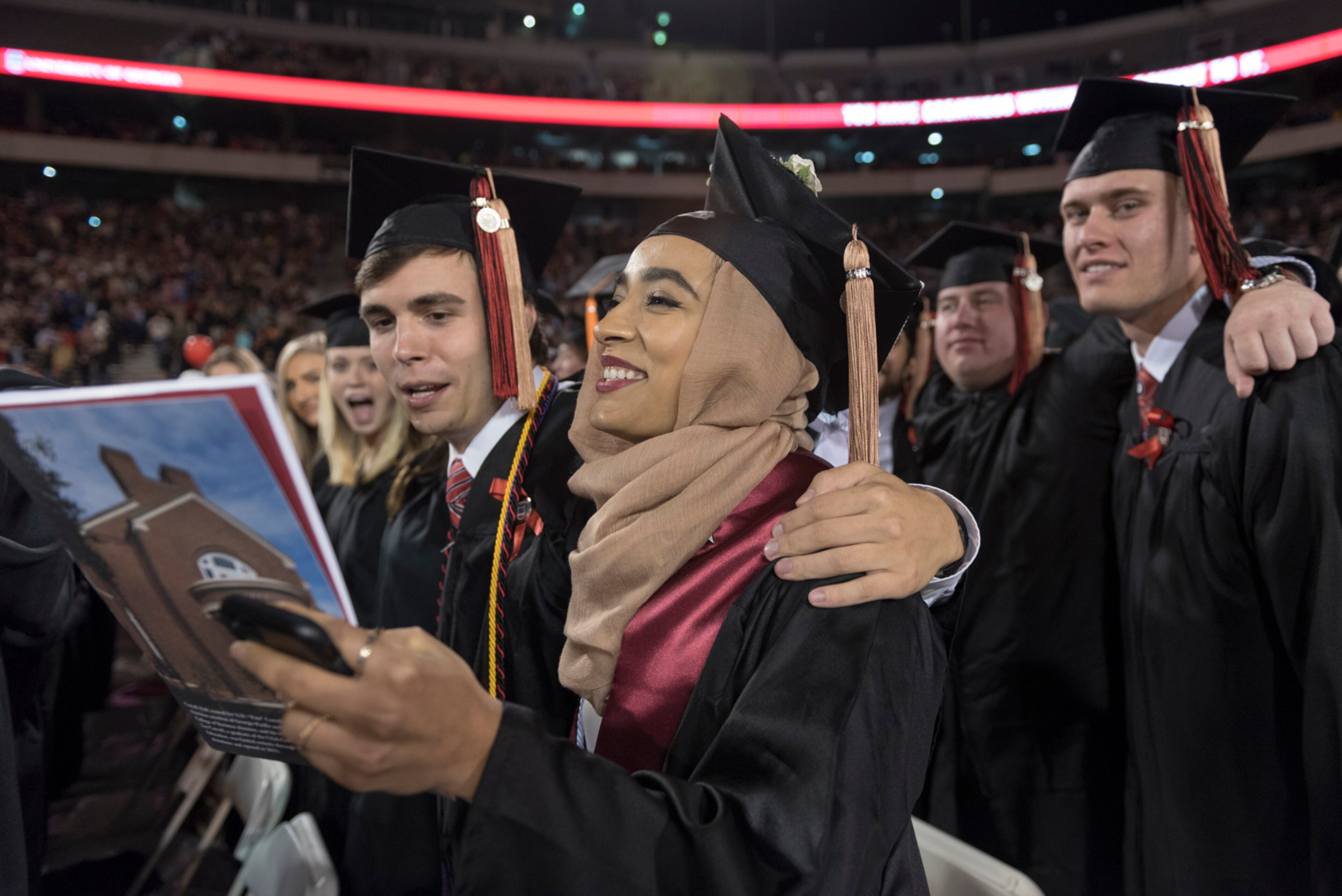 May 5, 2017, Athens - Students sing the Alma Mater during the University of Georgia's undergraduate commencement ceremony at Sanford Stadium in Athens, Georgia, on Friday, May 5, 2017. (DAVID BARNES / DAVID.BARNES@AJC.COM)