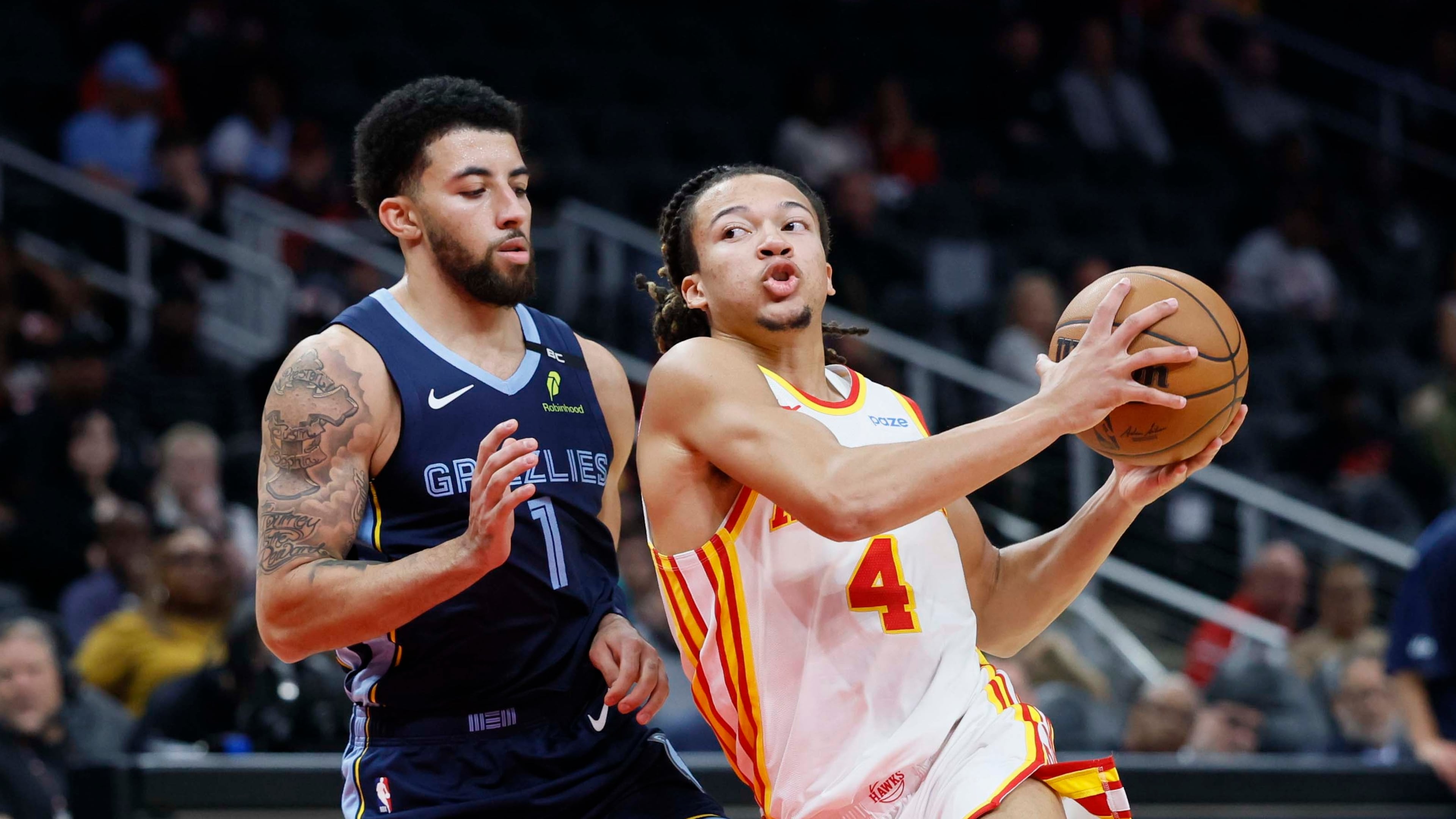 Atlanta Hawks guard Kingston Flemings (4) dribbles past Memphis Grizzlies guard Scotty Pippen Jr. (1) during the first half of a preseason NBA game at State Farm Arena in Atlanta, GA, on Monday, Oct. 5, 2026. (Miguel Martinez/AJC)