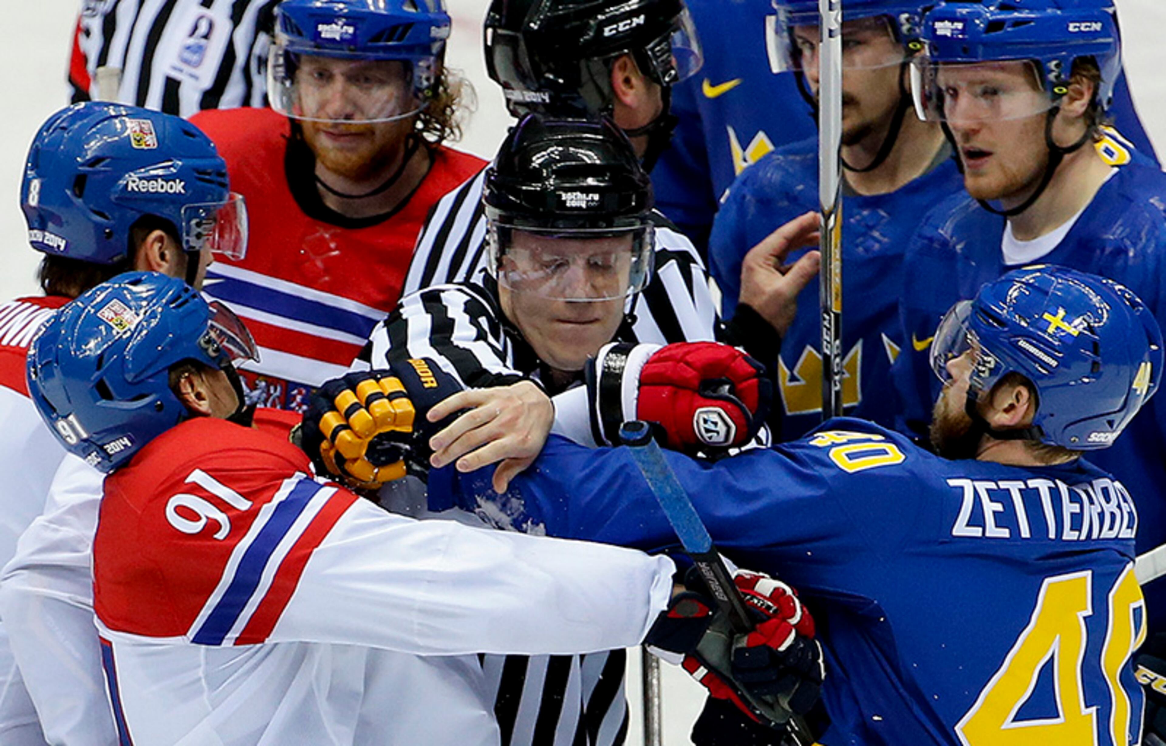A linesman breaks up a scuffle between Czech Republic forward Martin Erat (91) and Sweden forward Henrik Zetterberg in the third period of a men's ice hockey game at the 2014 Winter Olympics, Wednesday, Feb. 12, 2014, in Sochi, Russia.