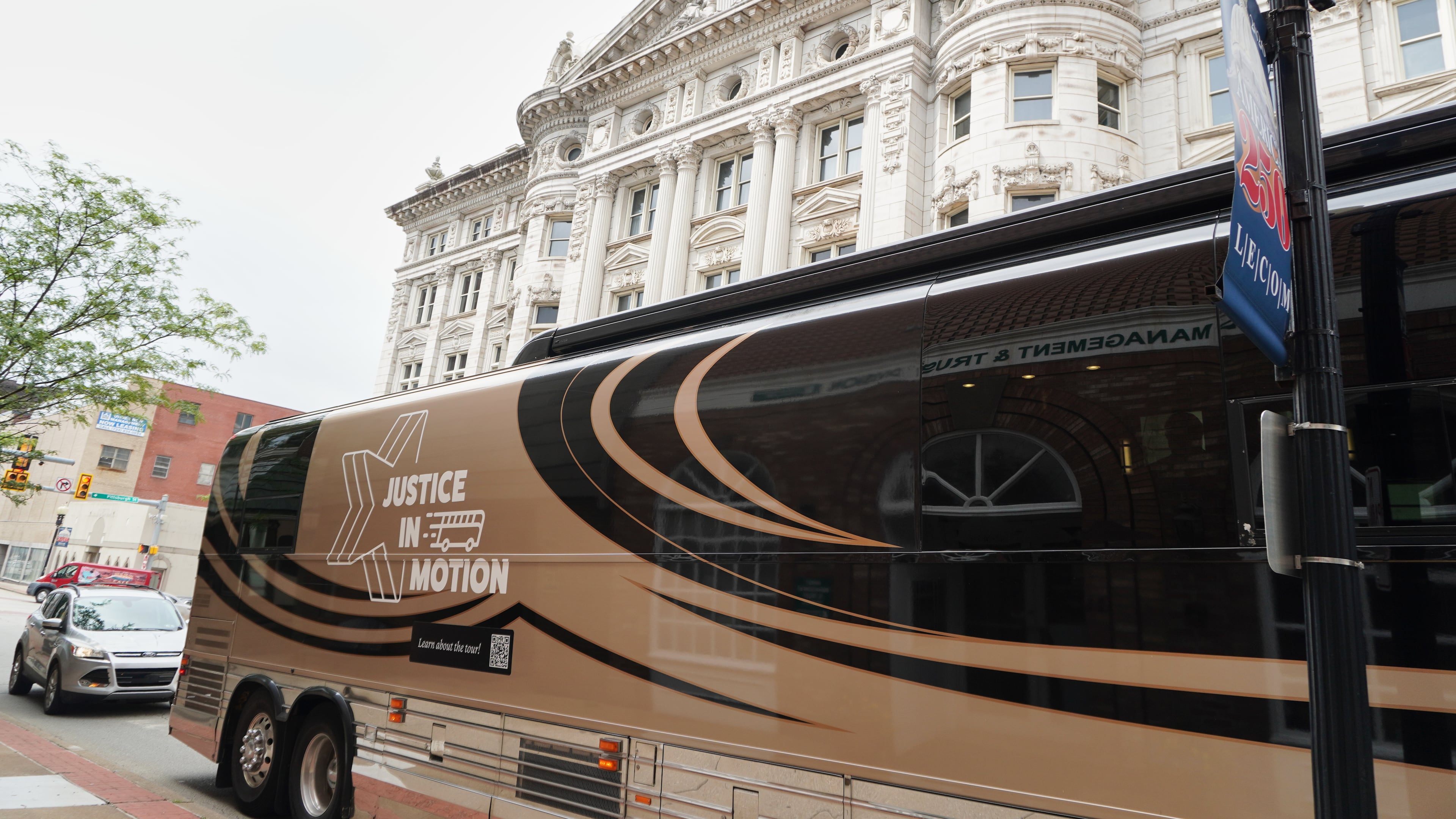 A tour bus carrying retired judges on a tour through the Rust Belt to defend judicial independence is parted outside the Westmoreland County Courthouse in Greensburg, Pa., on Tuesday, July 7, 2026. (Keep Our Republic via AP)