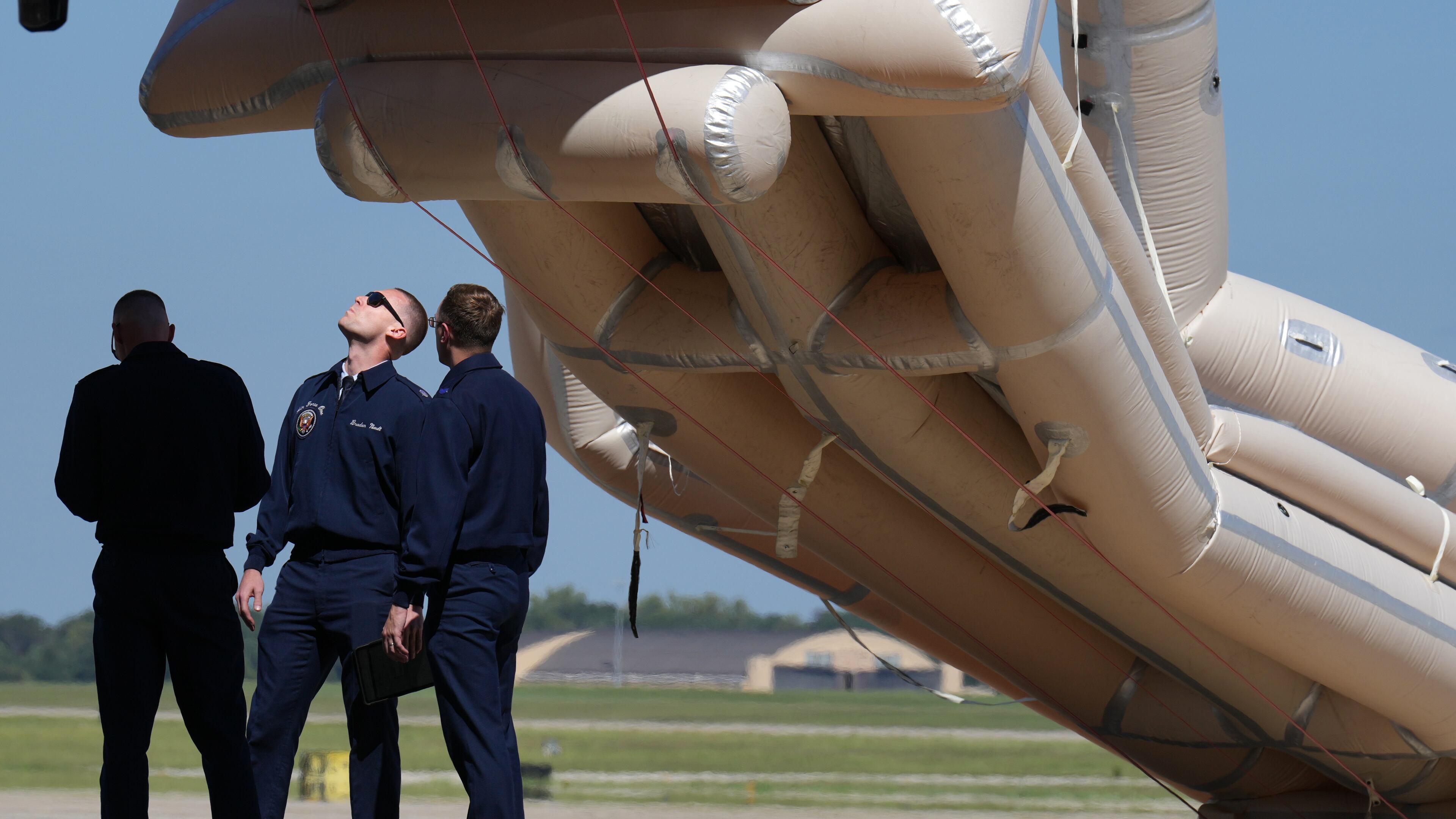 U.S, Air Force personnel work after an emergency inflatable slide deployed before President Donald Trump arrived to board at Joint Base Andrews, Md., Wednesday, Sept. 9, 2026. (AP Photo/Jacquelyn Martin)