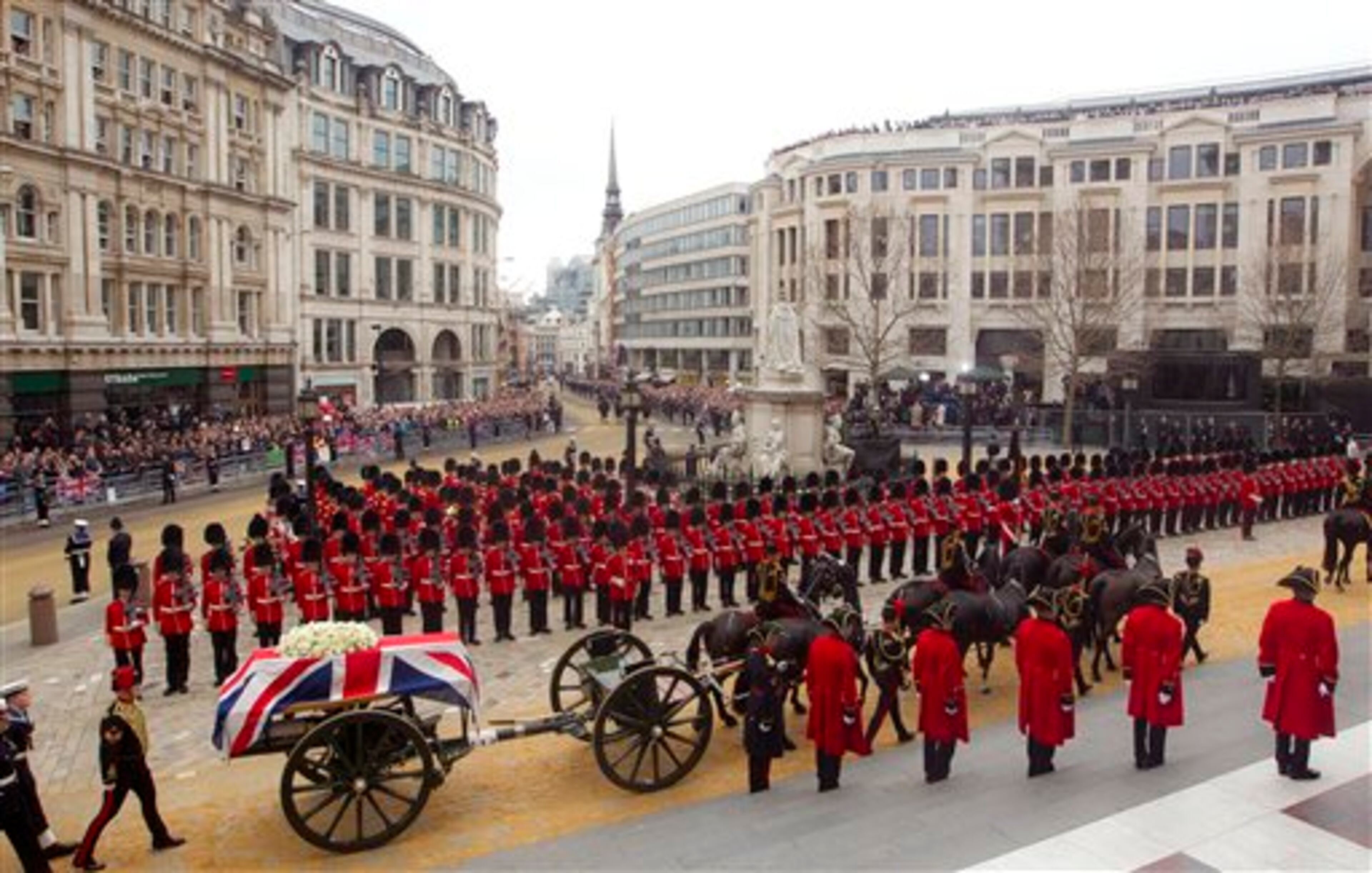 A Union flag draped coffin bearing the body of former British Prime Minister Margaret Thatcher is carried on a gun carriage drawn by the King's Troop Royal Artillery during her ceremonial funeral procession in London, Wednesday, April 17, 2013. A coffin containing the body of former Prime Minister Margaret Thatcher was driven Wednesday from the Houses of Parliament to the church of St. Clement Danes for prayers ahead of the former leader's full funeral at St. Paul's Cathedral. (AP Photo/Joel Ryan, Pool)