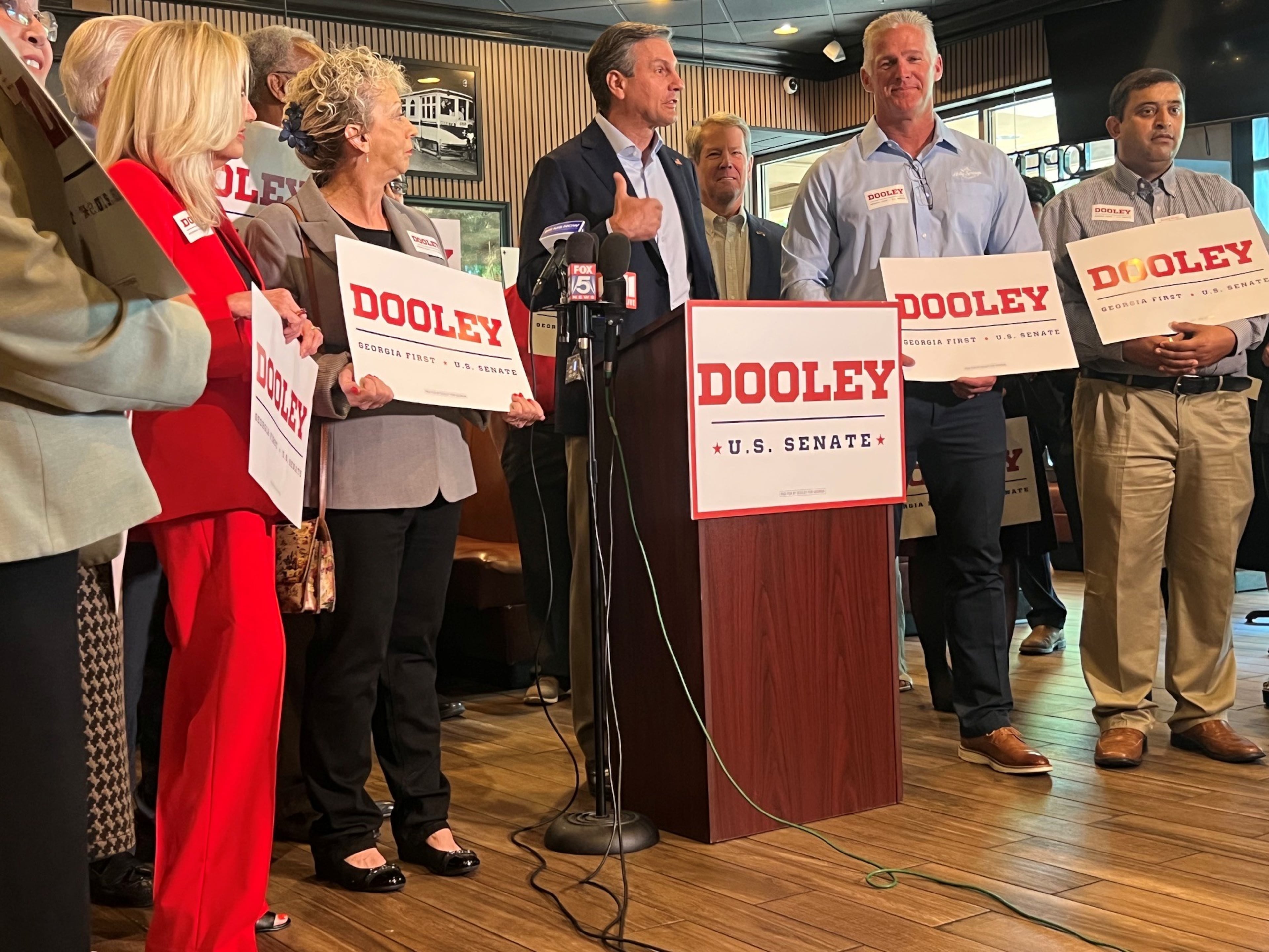 Derek Dooley makes his final case before the GOP primary in Georgia's U.S. Senate race, with Gov. Brian Kemp behind him, at West Cobb Diner in Dallas. (Patricia Murphy/AJC)