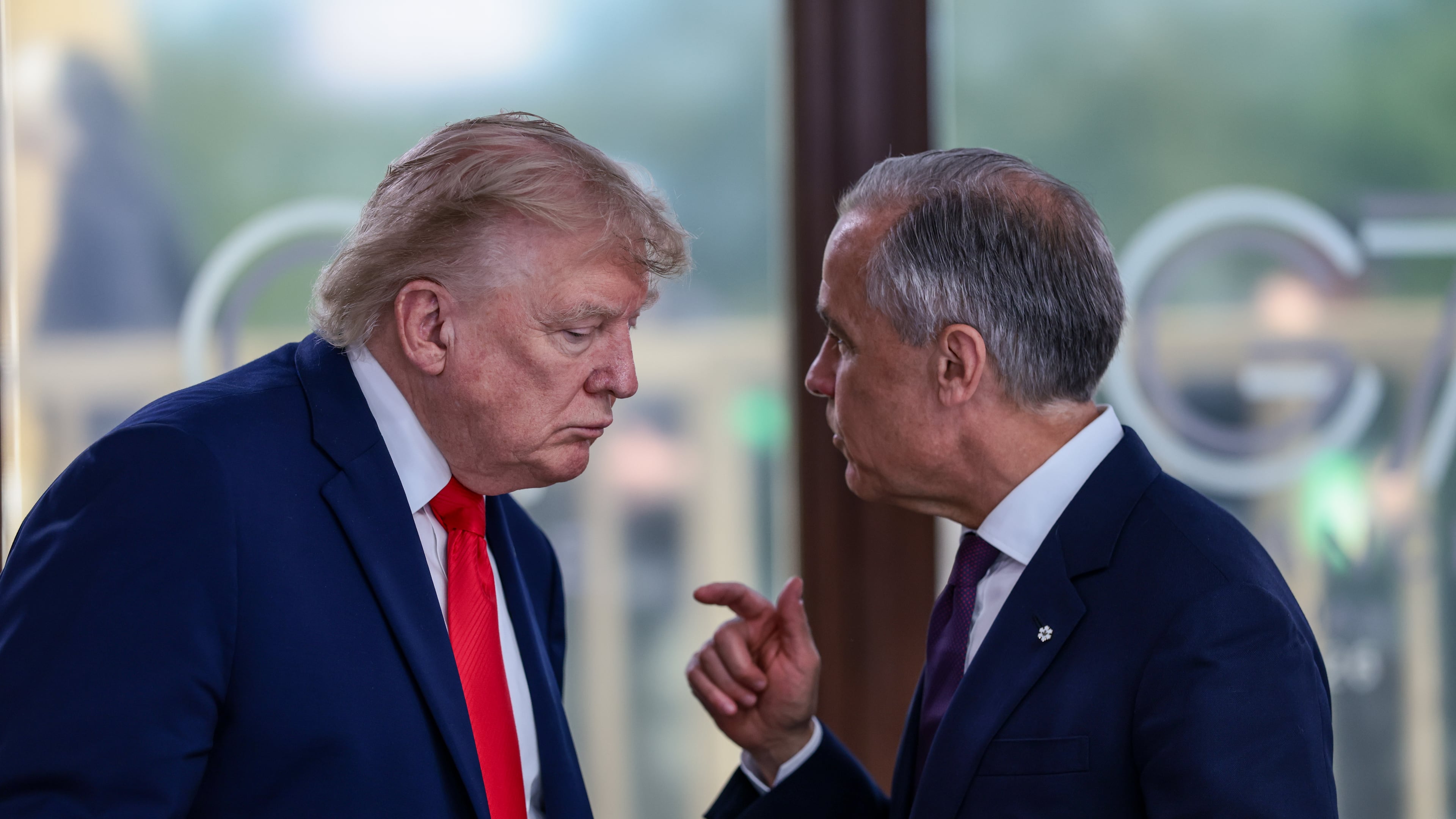 FILE - President Donald Trump speaks with Canadian Prime Minister Mark Carney, right, at a working lunch with leaders of G7 and the Middle East in Evian-les-Bains, France, Tuesday, June 16, 2026. (Evelyn Hockstein/Pool Photo via AP,File)