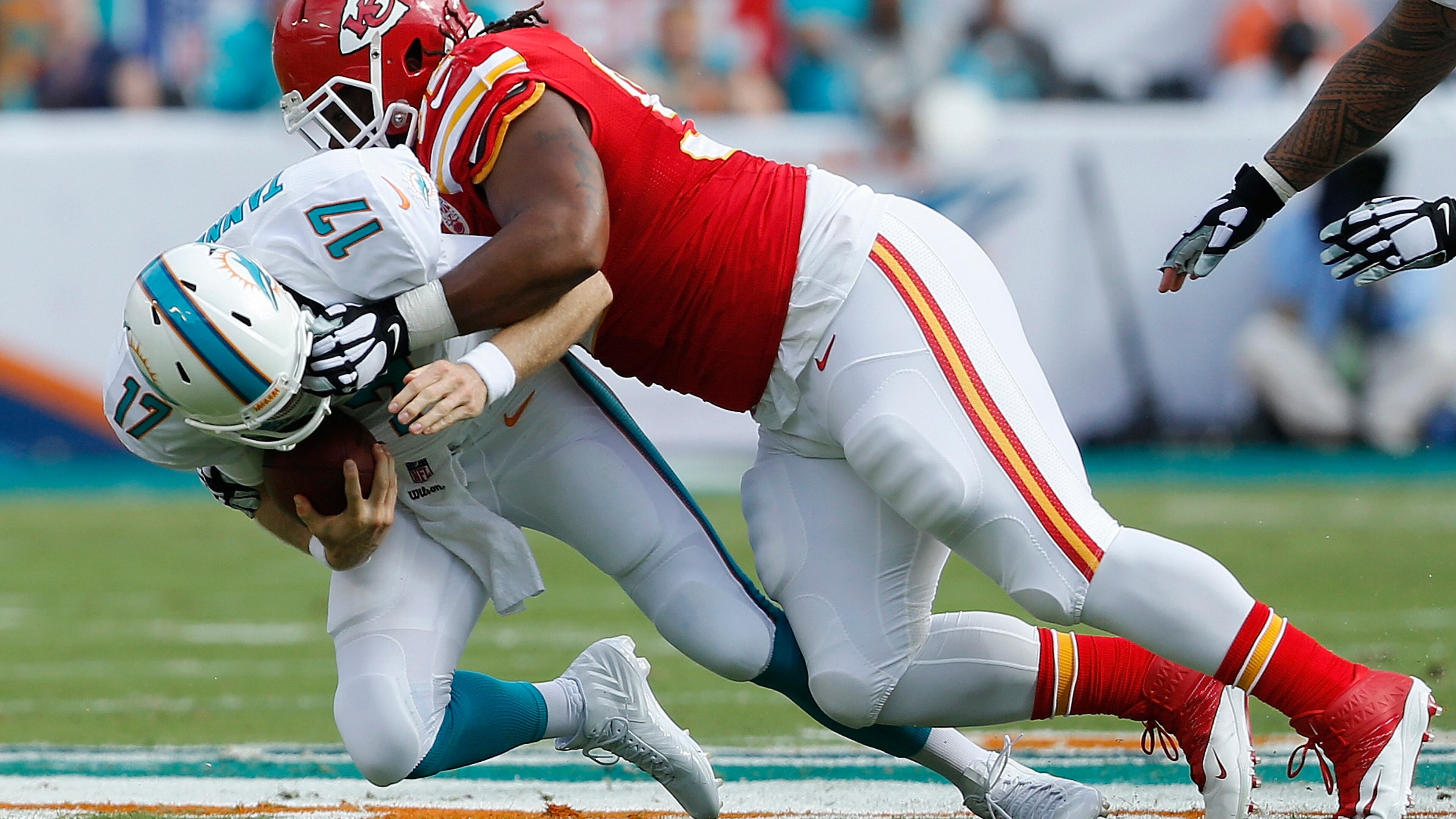MIAMI GARDENS, FL - SEPTEMBER 21: Quarterback Ryan Tannehill #17 of the Miami Dolphins is brought down by nose tackle Dontari Poe #92 of the Kansas City Chiefs in the first quarter at Sun Life Stadium on September 21, 2014 in Miami Gardens, Florida. (Photo by Joel Auerbach/Getty Images)
