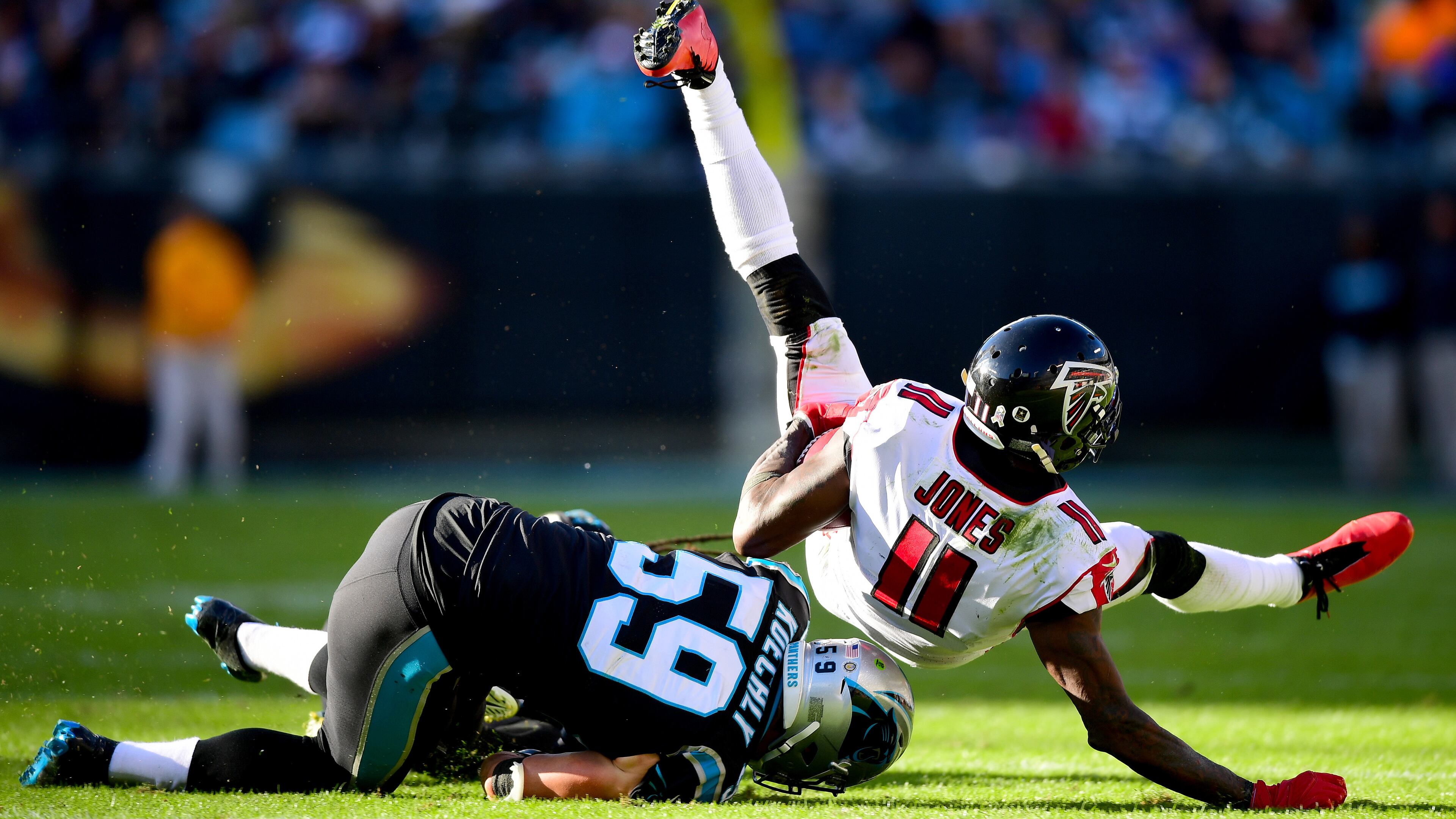 Falcons wide receiver Julio Jones is brought down by Carolina's Tre Boston and Luke Kuechly (59) during the third quarter Sunday, Nov. 17, 2019, at Bank of America Stadium in Charlotte.