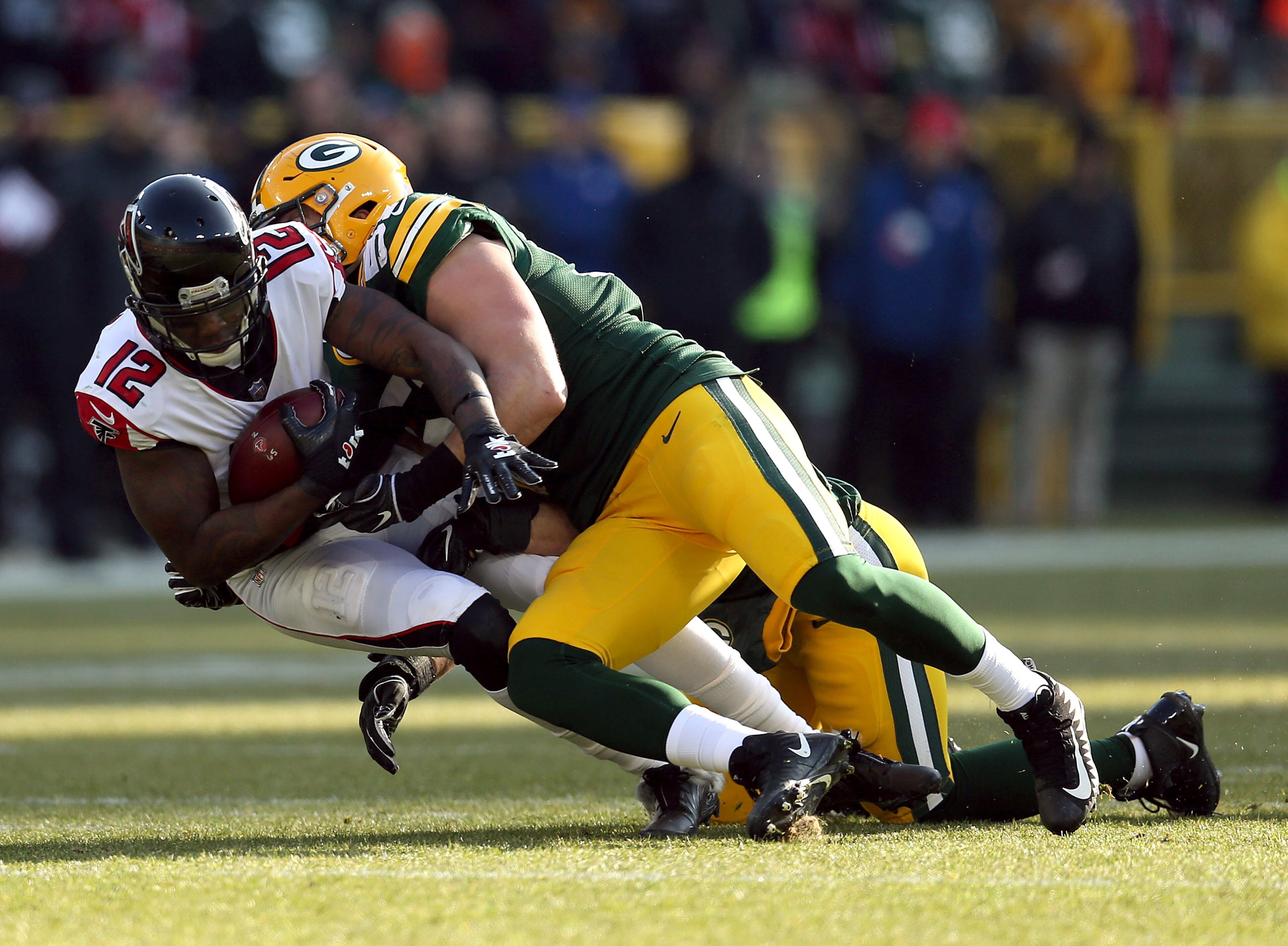 GREEN BAY, WISCONSIN - DECEMBER 09: Mohamed Sanu #12 of the Atlanta Falcons is tackled by Kyler Fackrell #51 of the Green Bay Packers during the first half of a game at Lambeau Field on December 09, 2018 in Green Bay, Wisconsin. (Photo by Dylan Buell/Getty Images)