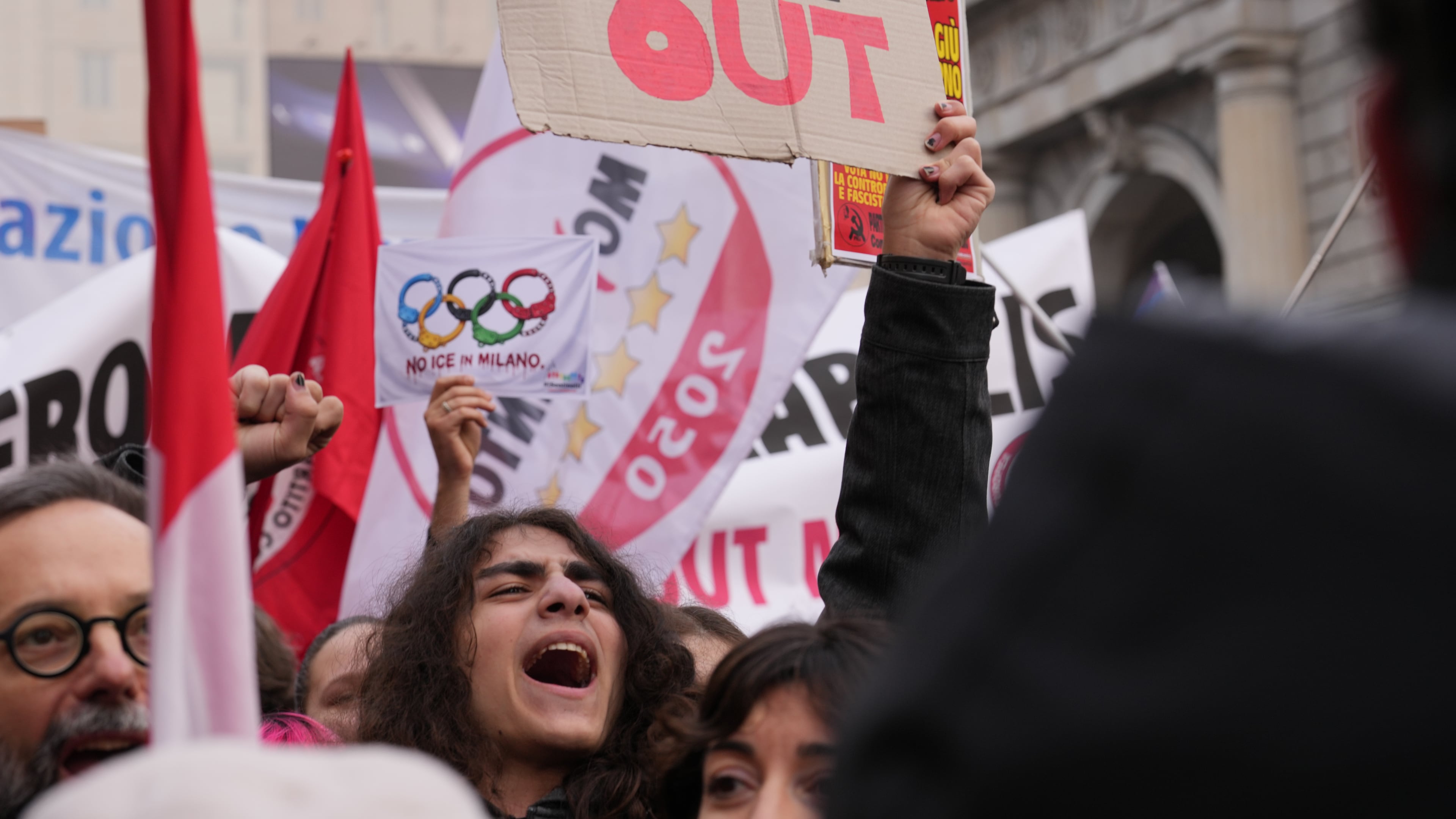 A person holds a sign, during an Anti-ICE demonstration, ahead of the 2026 Winter Olympics, in Milan, Italy, Saturday, Jan. 31, 2026. (AP Photo/Antonio Calanni)