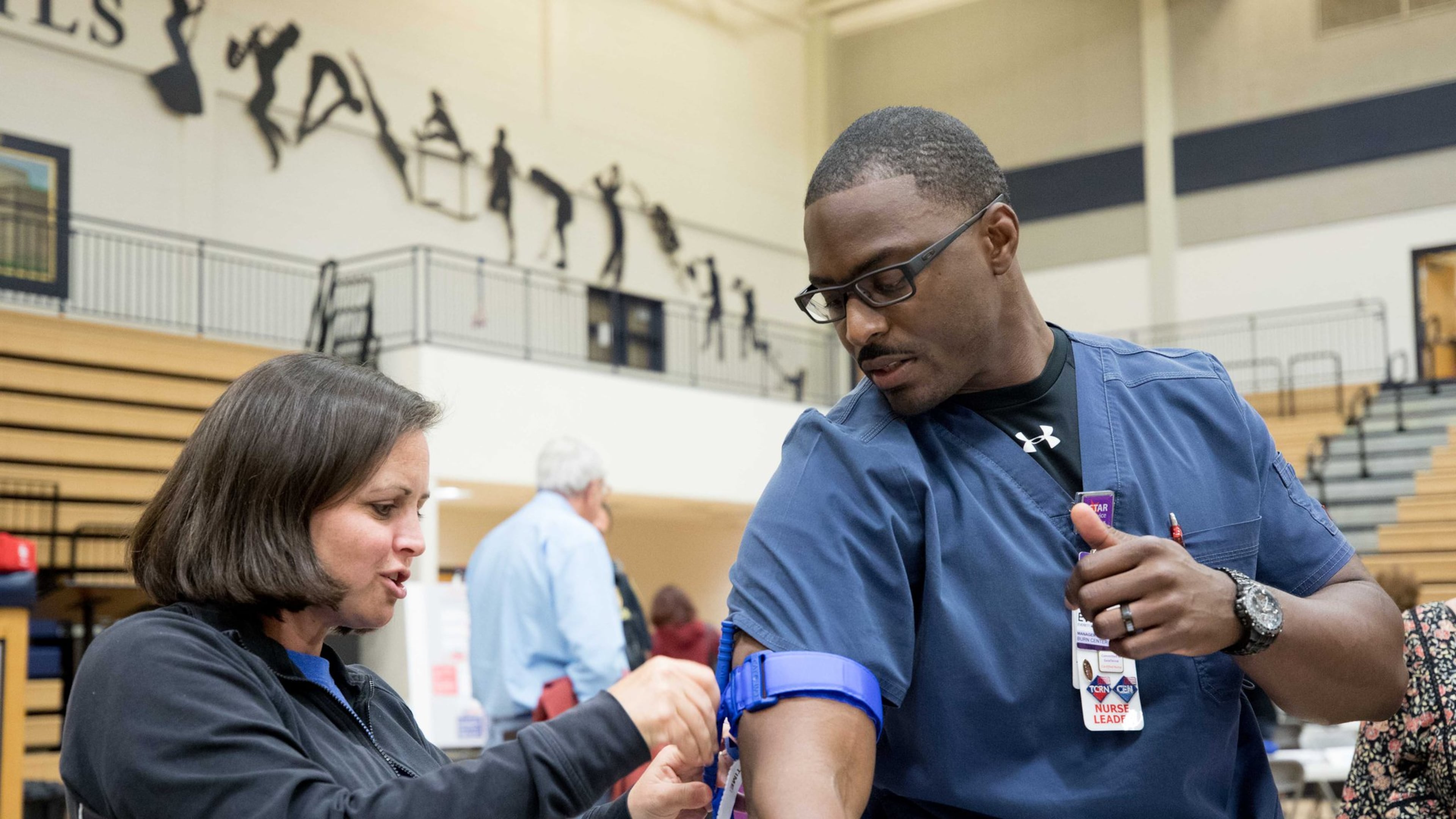 East Side Elementary teacher Amy McGehee, left, practices putting a tourniquet on nurse Everett Moss II during an active shooter training seminar at Marietta High School, Monday, Feb. 26, 2018, in Marietta, Ga. BRANDEN CAMP/SPECIAL