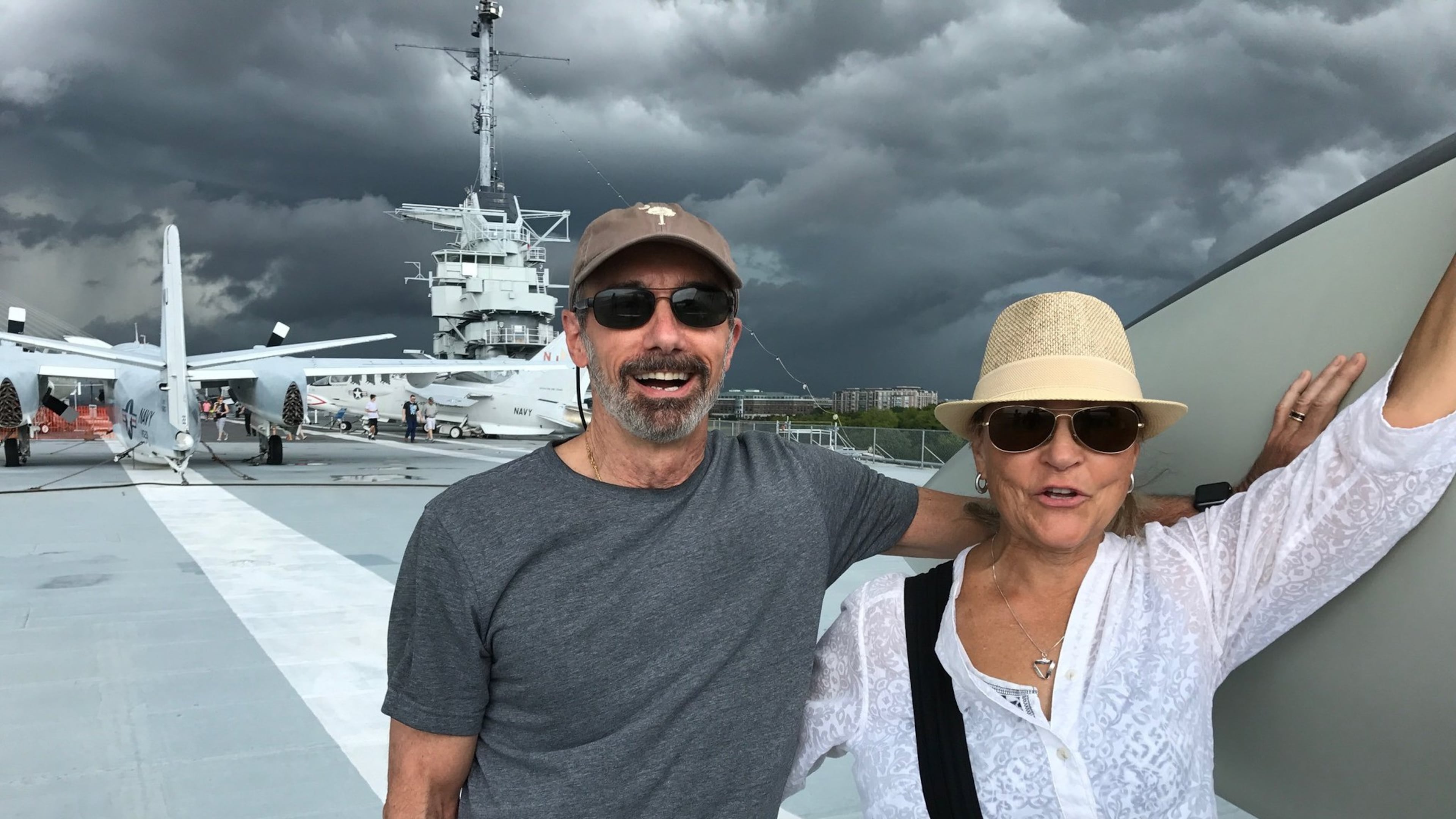 Larry and Nancy Feinberg of Charleston, S.C., watch storm clouds from the deck of the USS Yorktown, where an eclipse-watching party of 2,500 will gather on Aug. 21. BO EMERSON / BEMERSON@AJC.COM